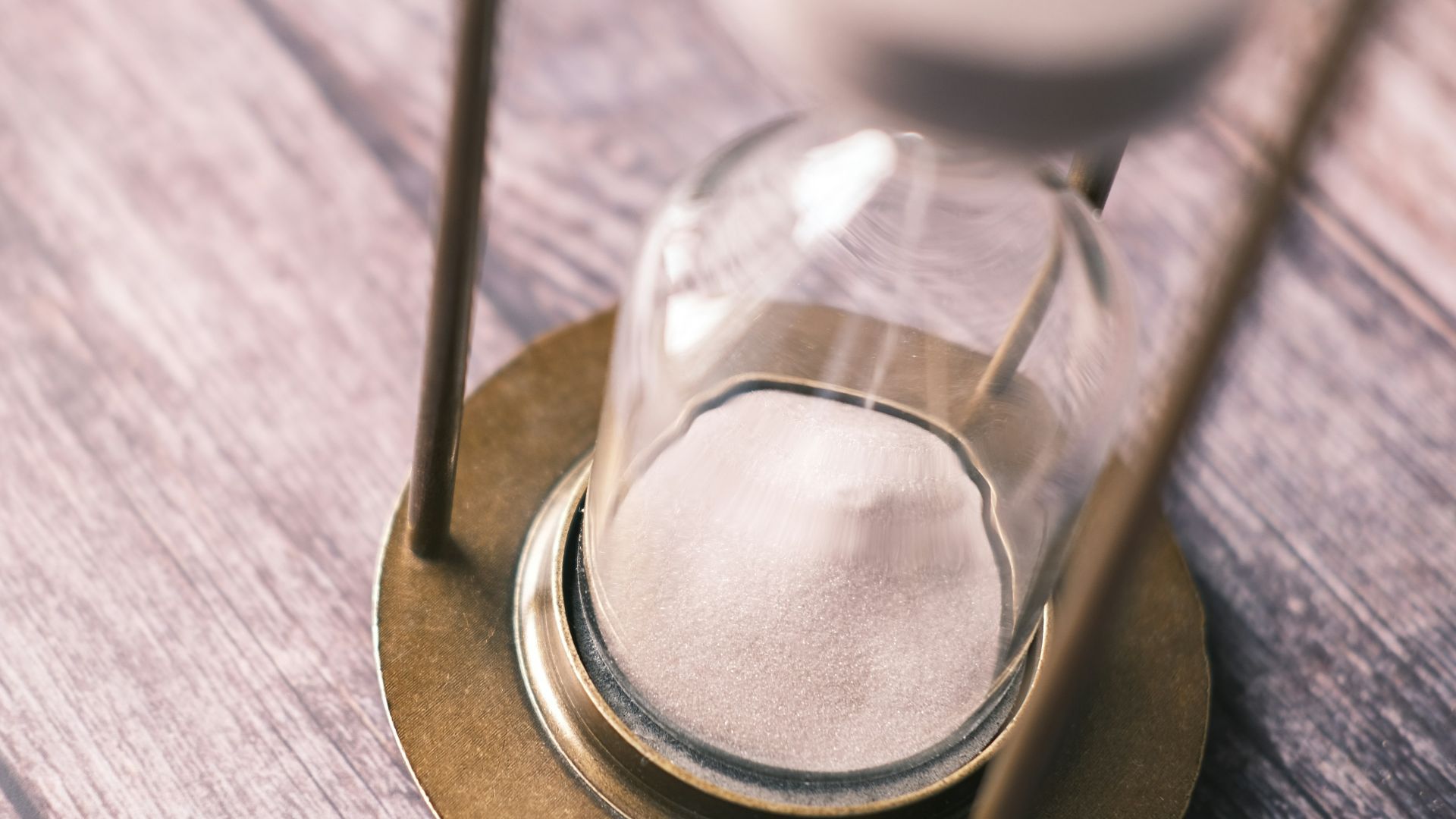an hourglass sitting on top of a wooden table