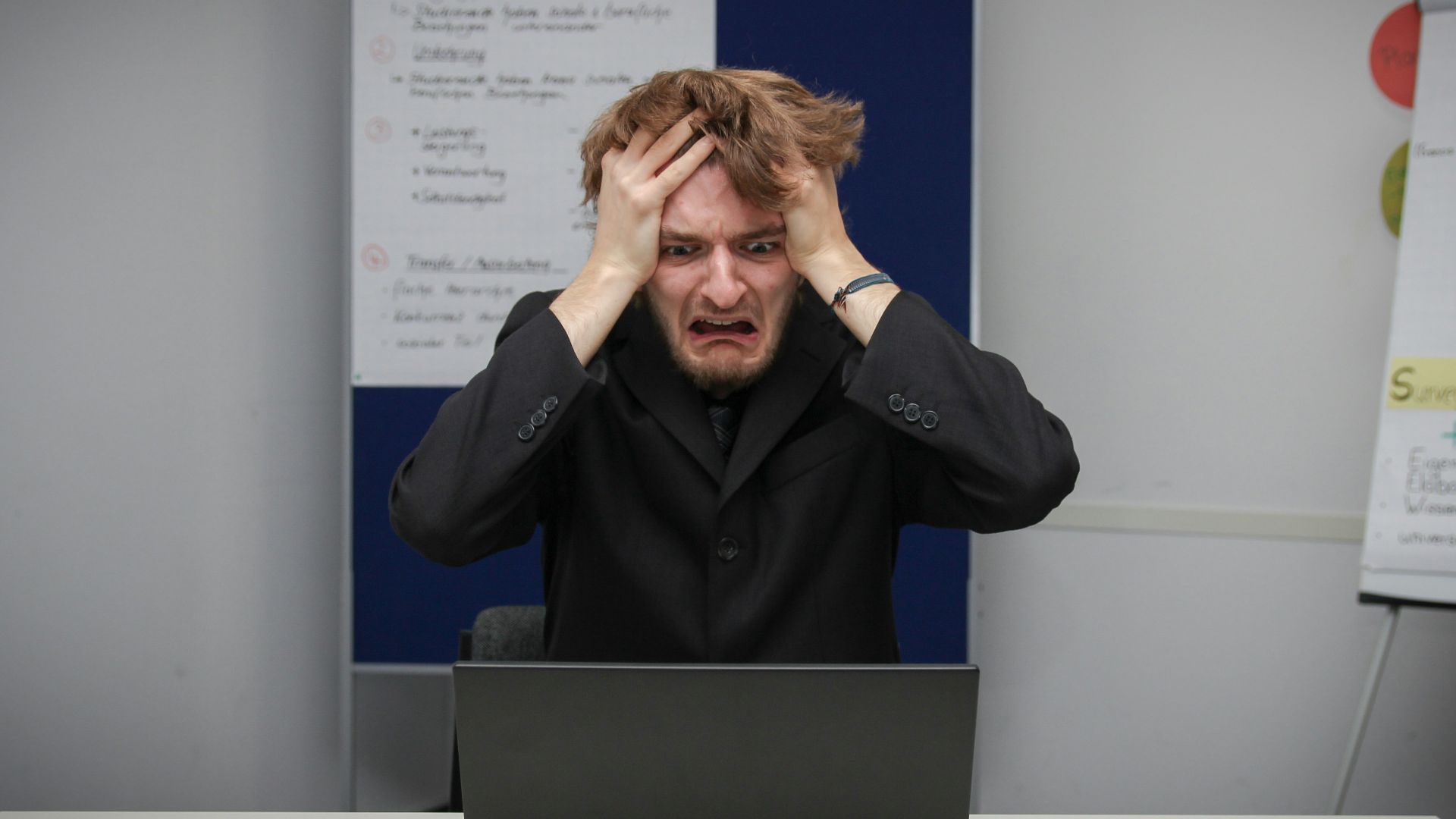 A man sitting in front of a laptop computer