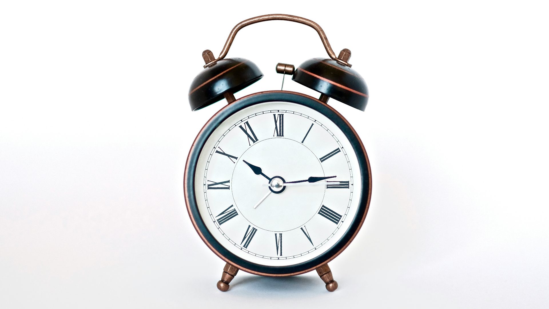 round black and white analog alarm clock