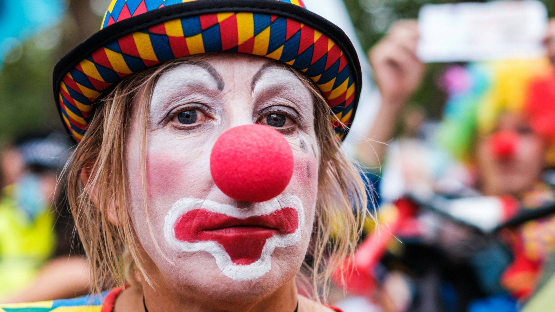 woman in yellow and red stripe shirt with white and red candy on face