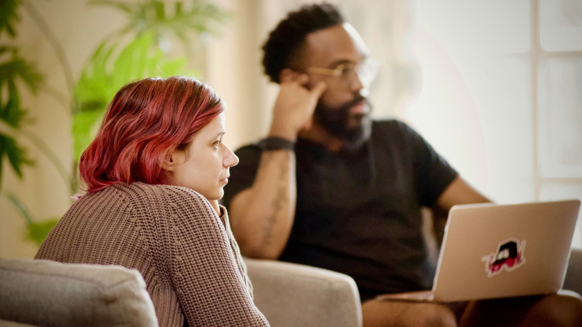 woman in black crew neck shirt sitting on brown chair