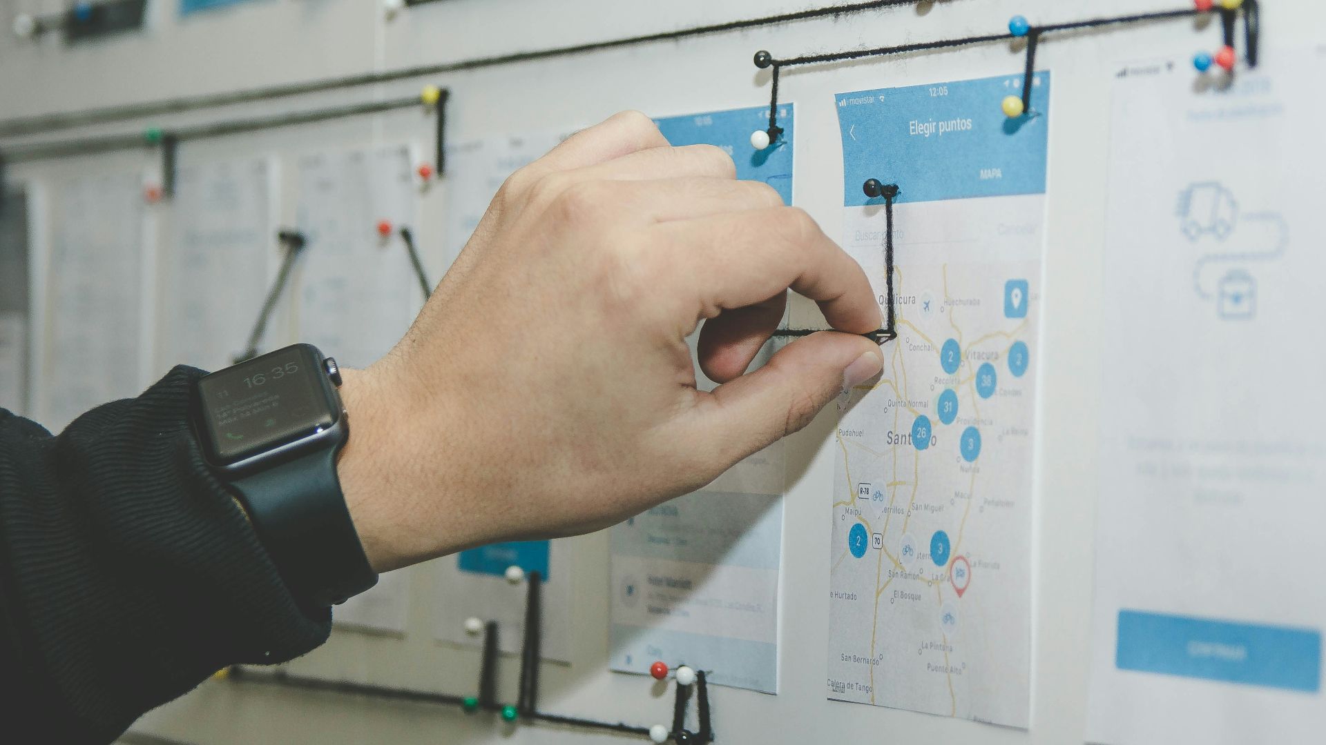 person working on blue and white paper on board