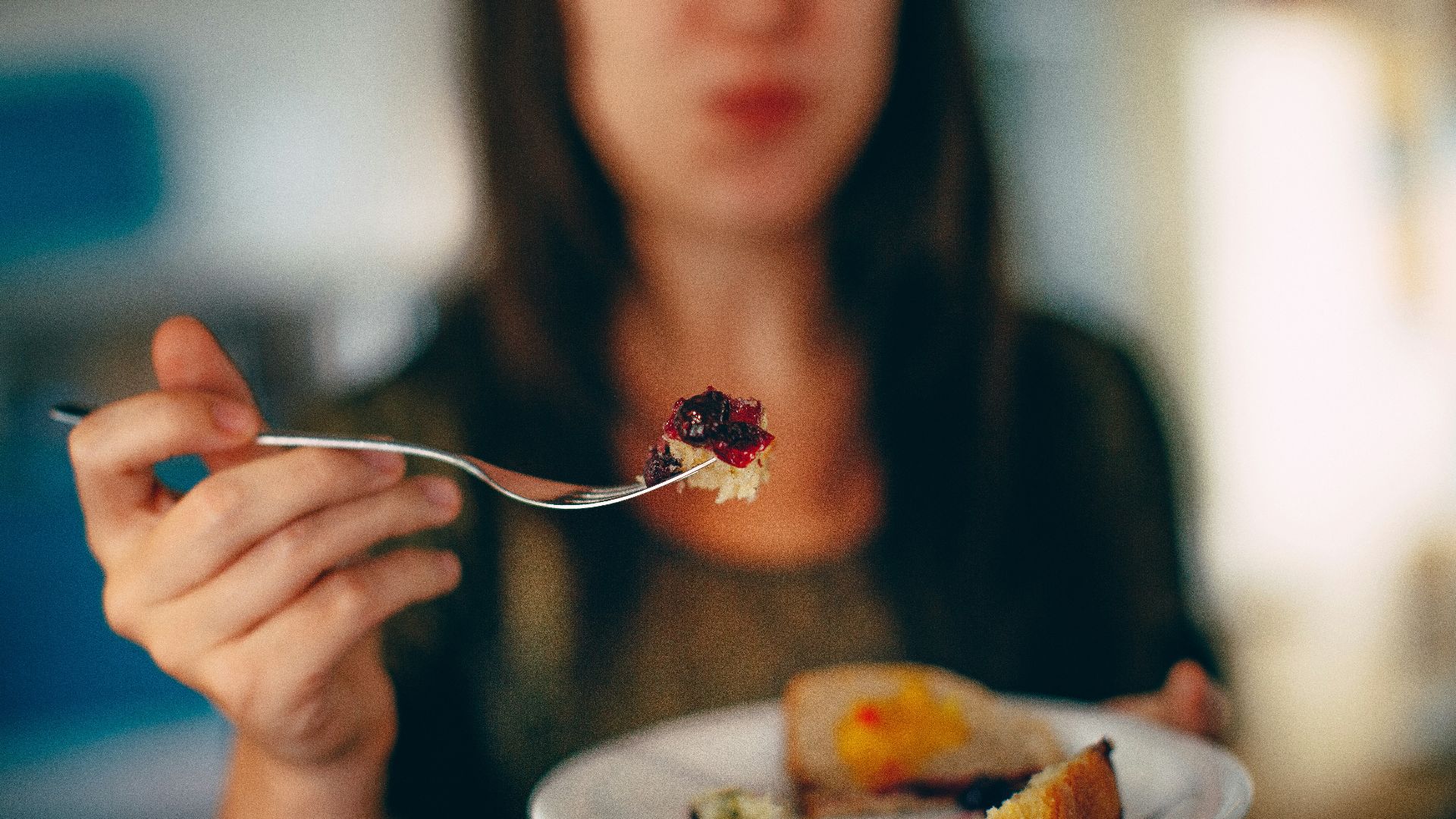 woman holding plate of cake