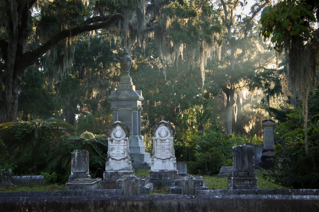 A cemetery with several headstones and trees in the background