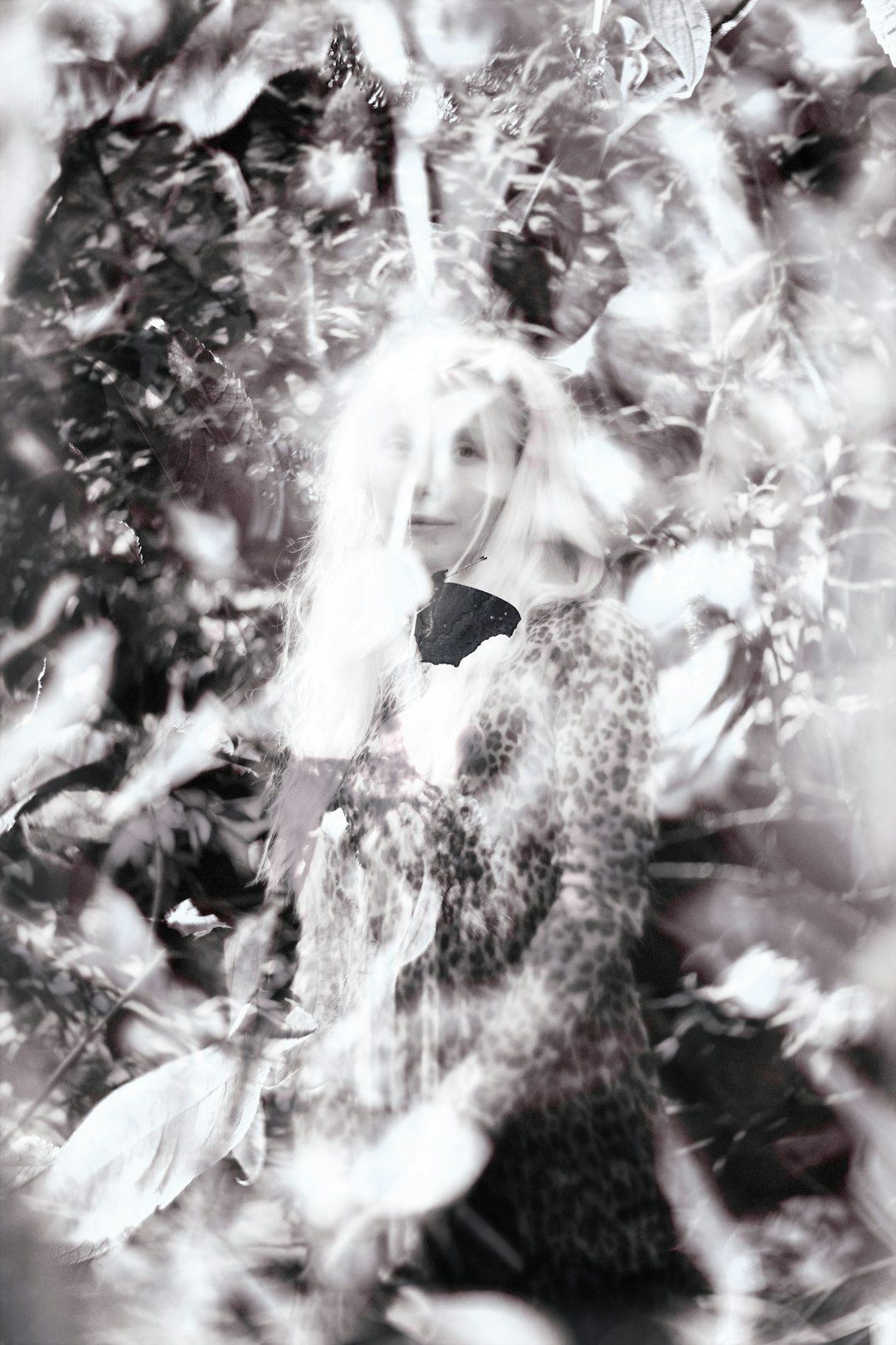 A black and white photo of a woman in a dress