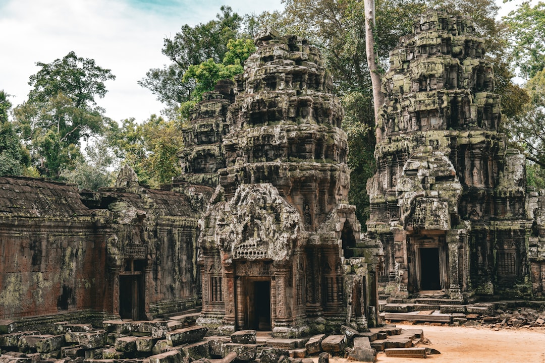 a group of stone buildings with trees in the background