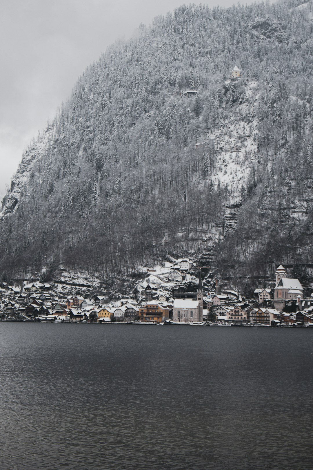 a large body of water with a mountain in the background