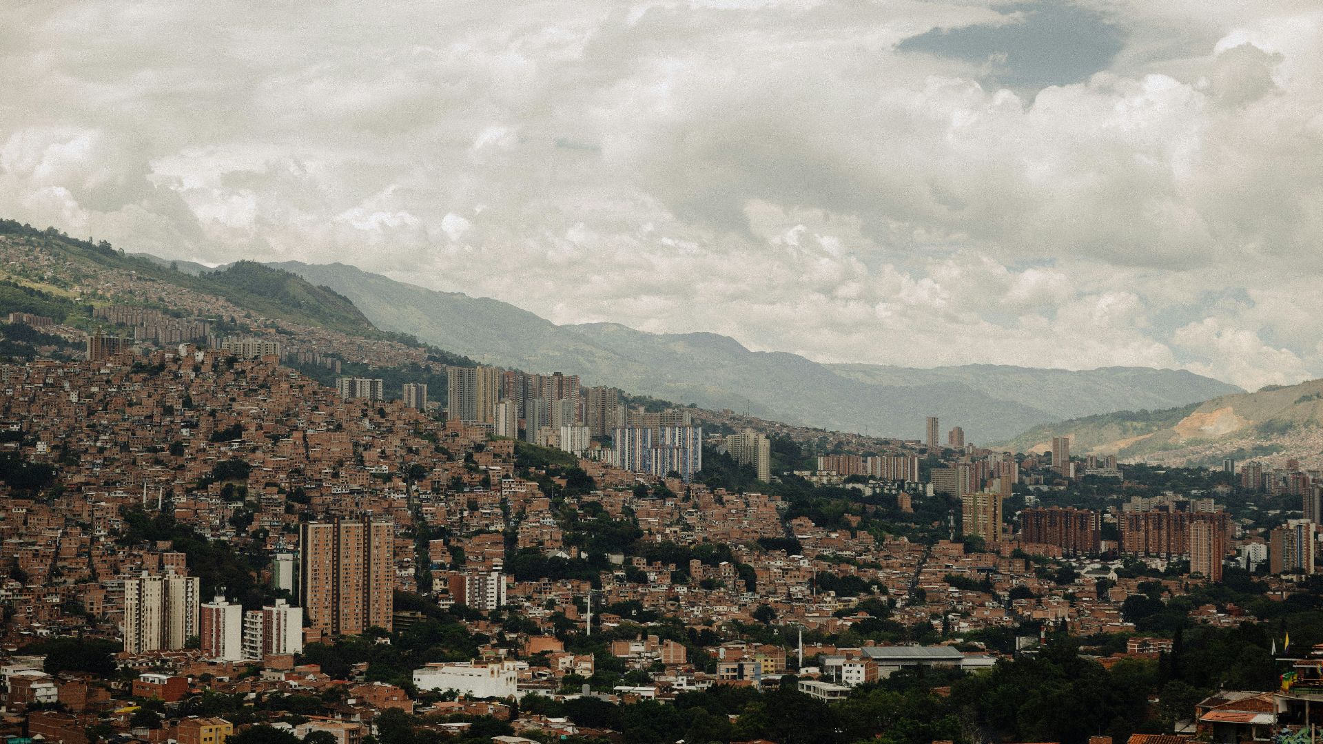 a view of a city with mountains in the background