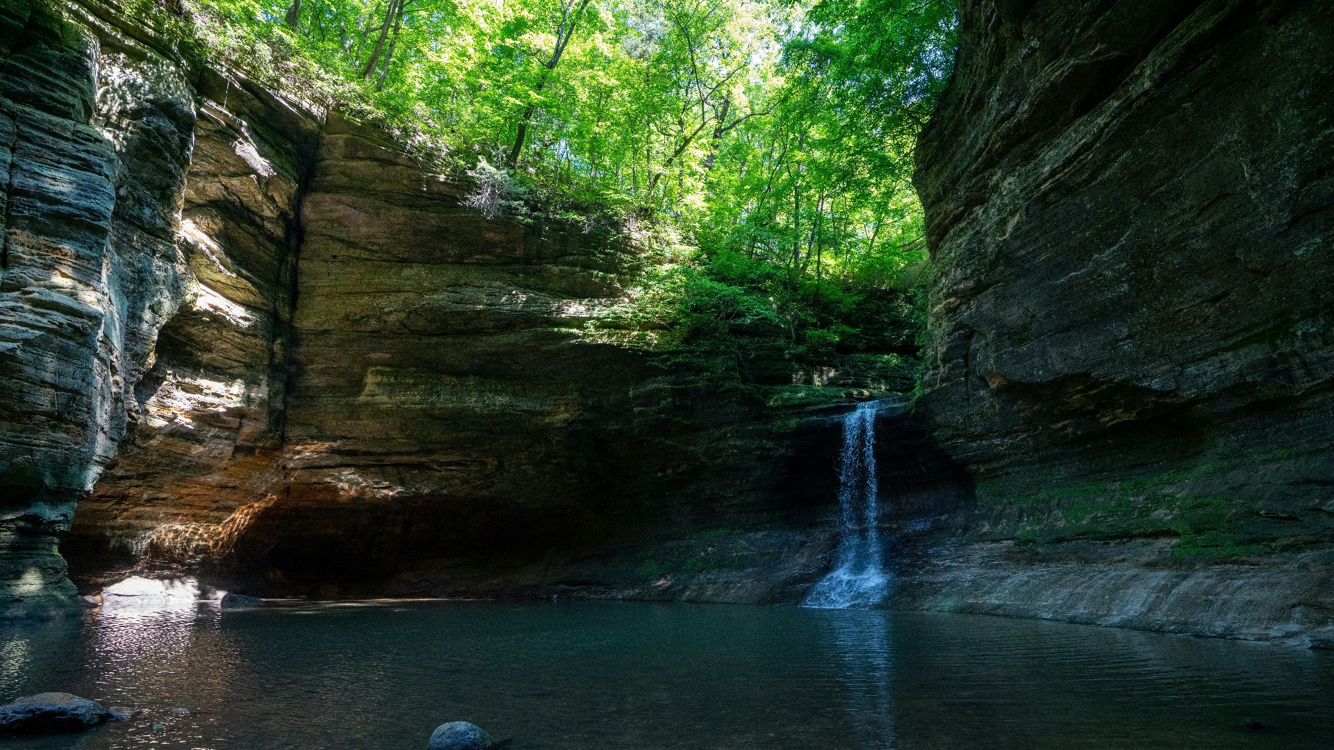 brown rock formation on river