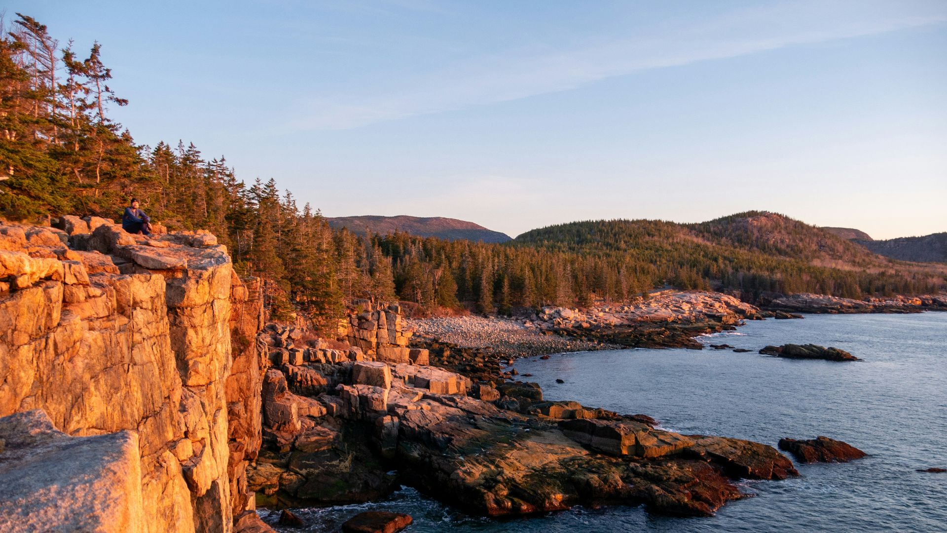 a rocky cliff overlooks a body of water
