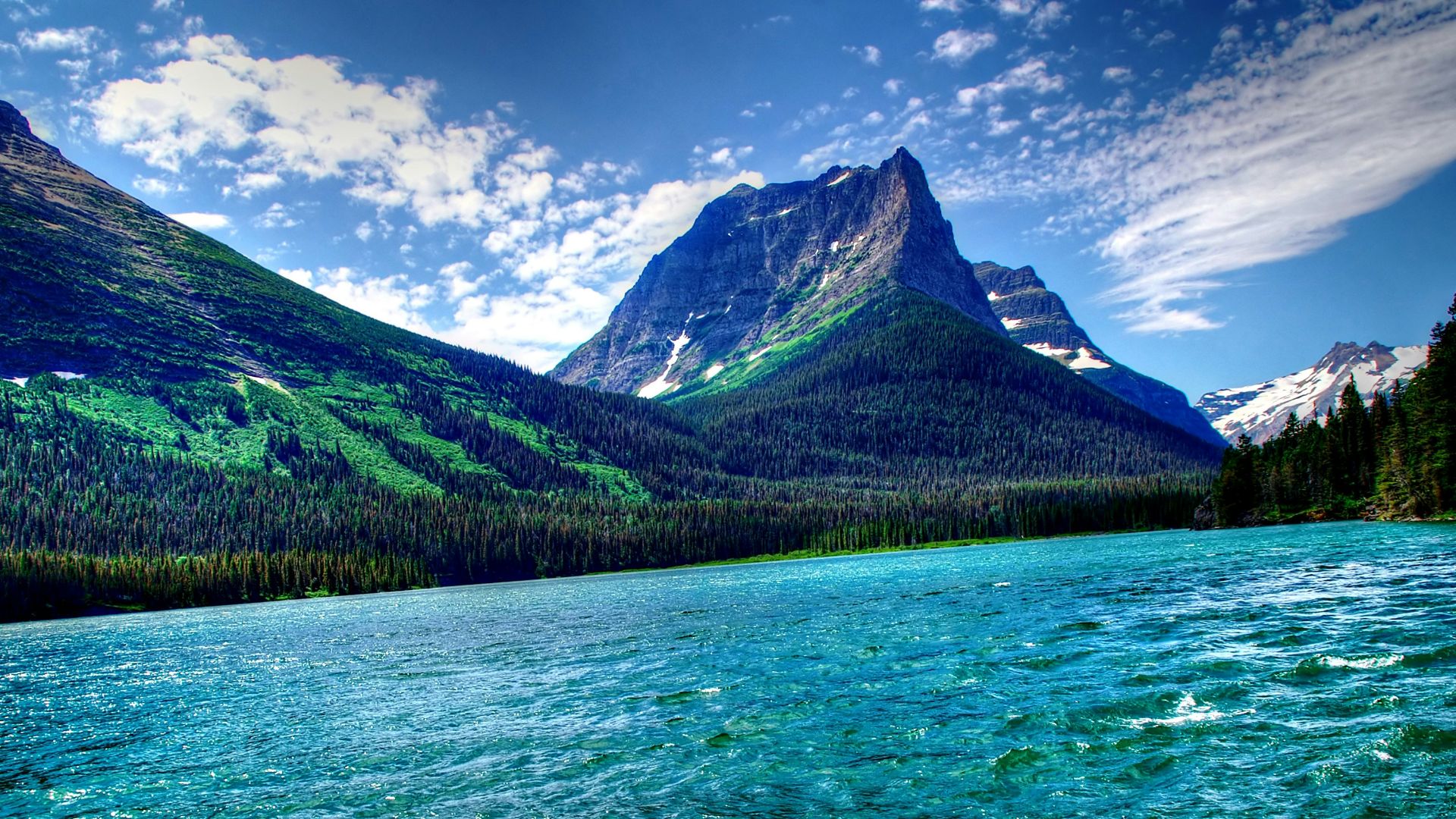 a body of water with mountains in the background
