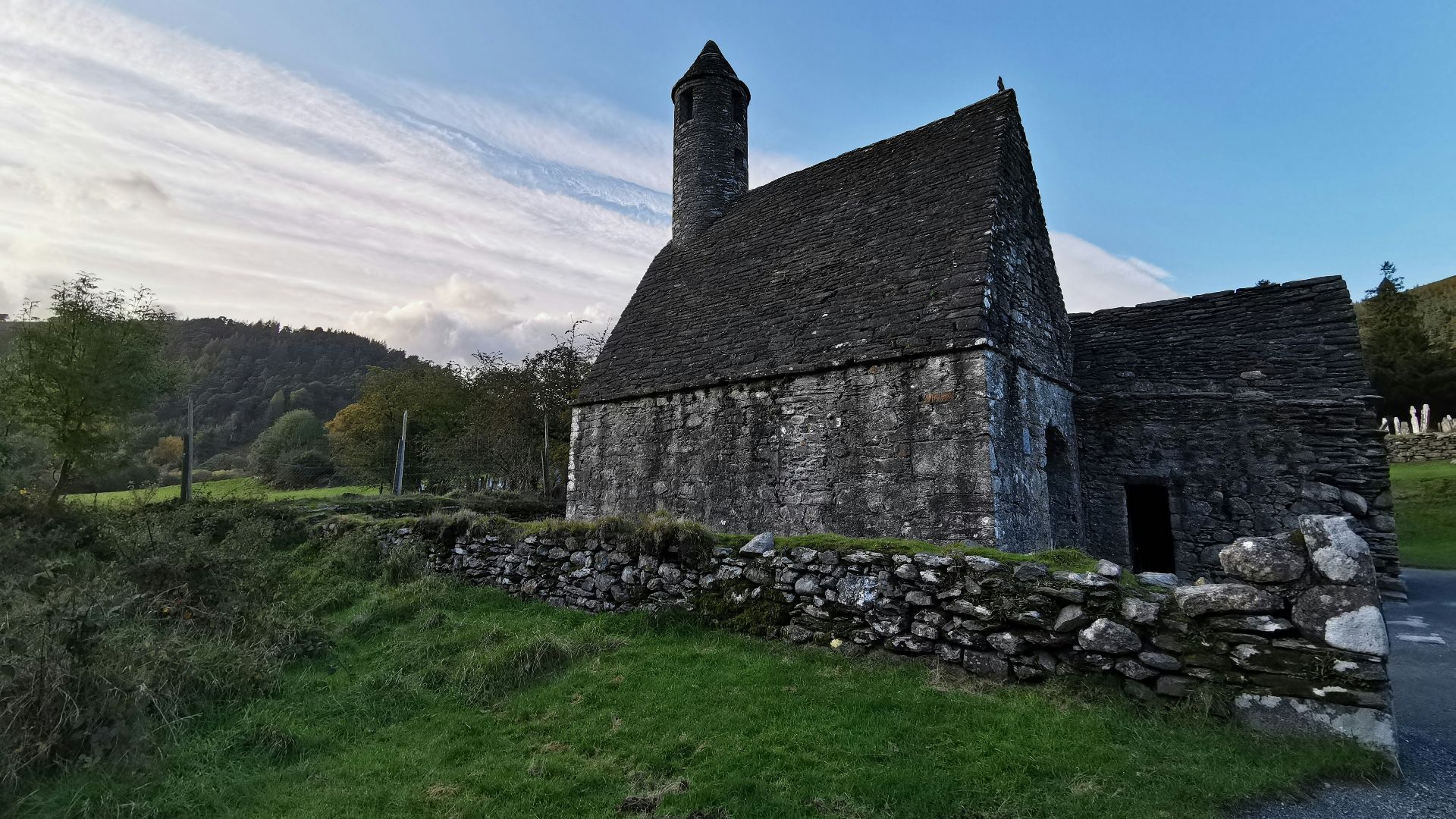 gray concrete building on green grass field under white sky during daytime