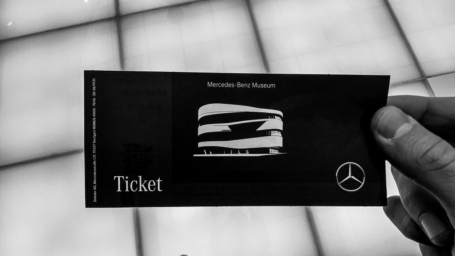 a person holding up a ticket in front of a window