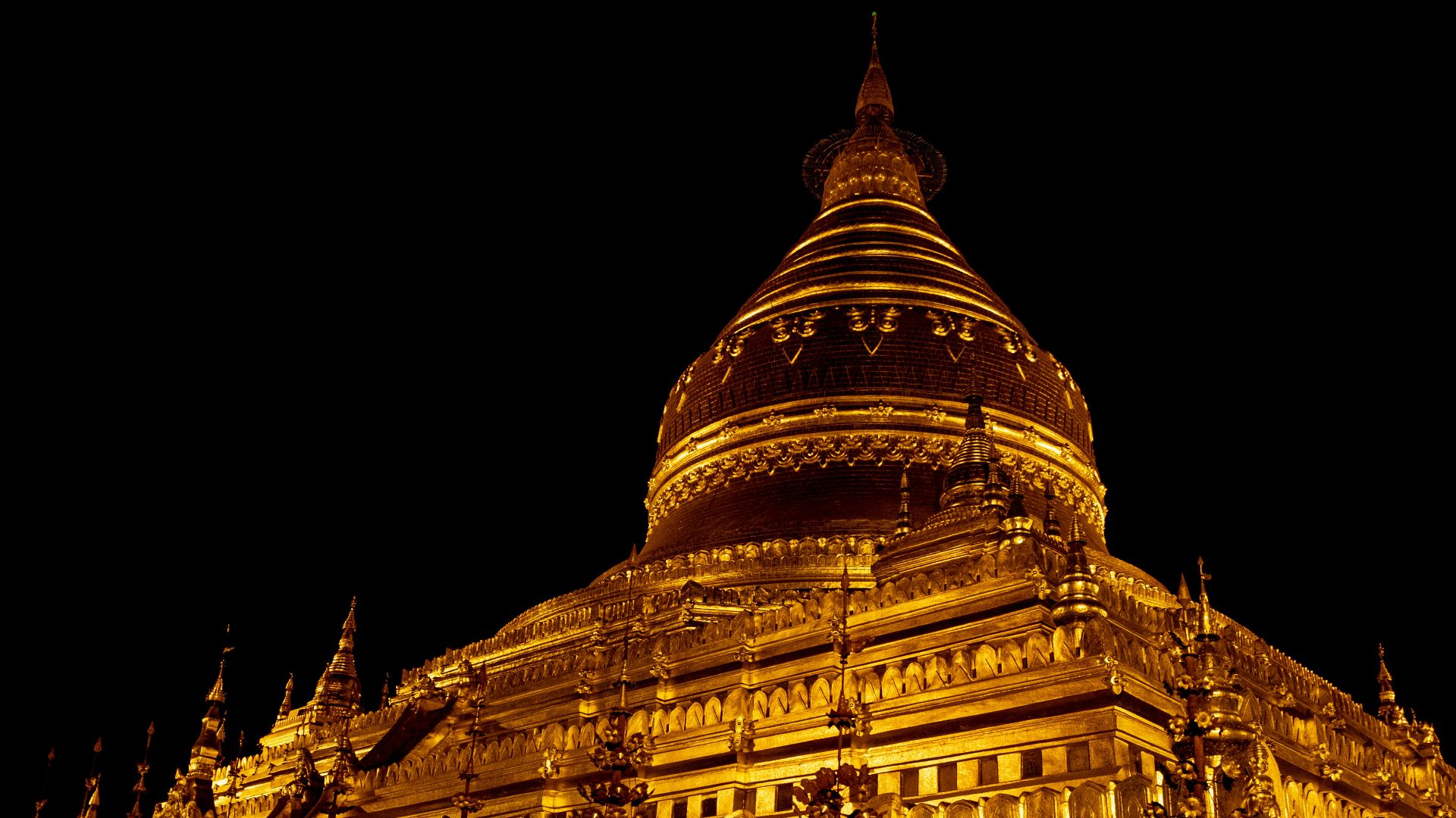 a large building lit up at night with lights on it