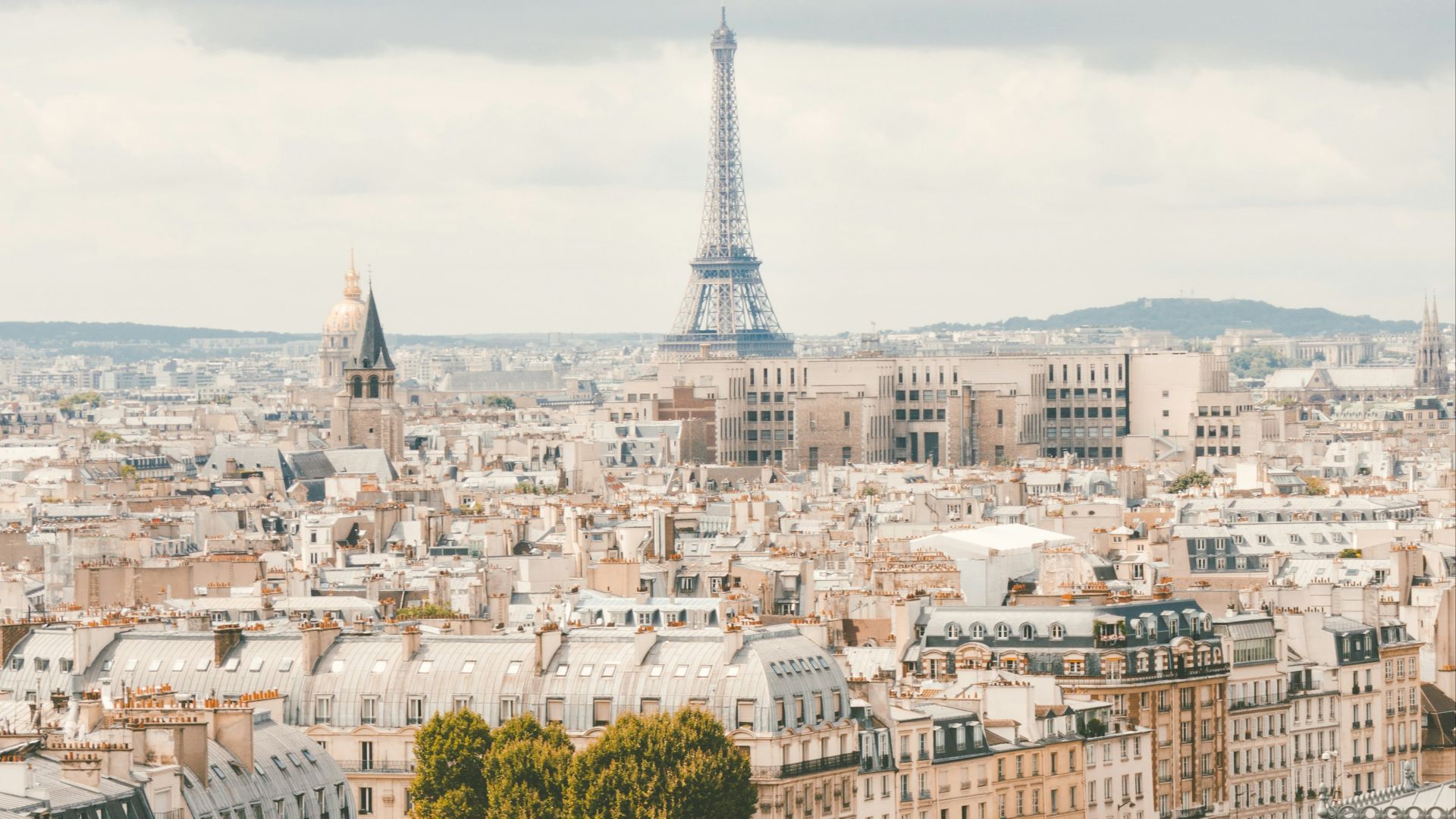 group of people walking near body of water and building under blue sky at daytime