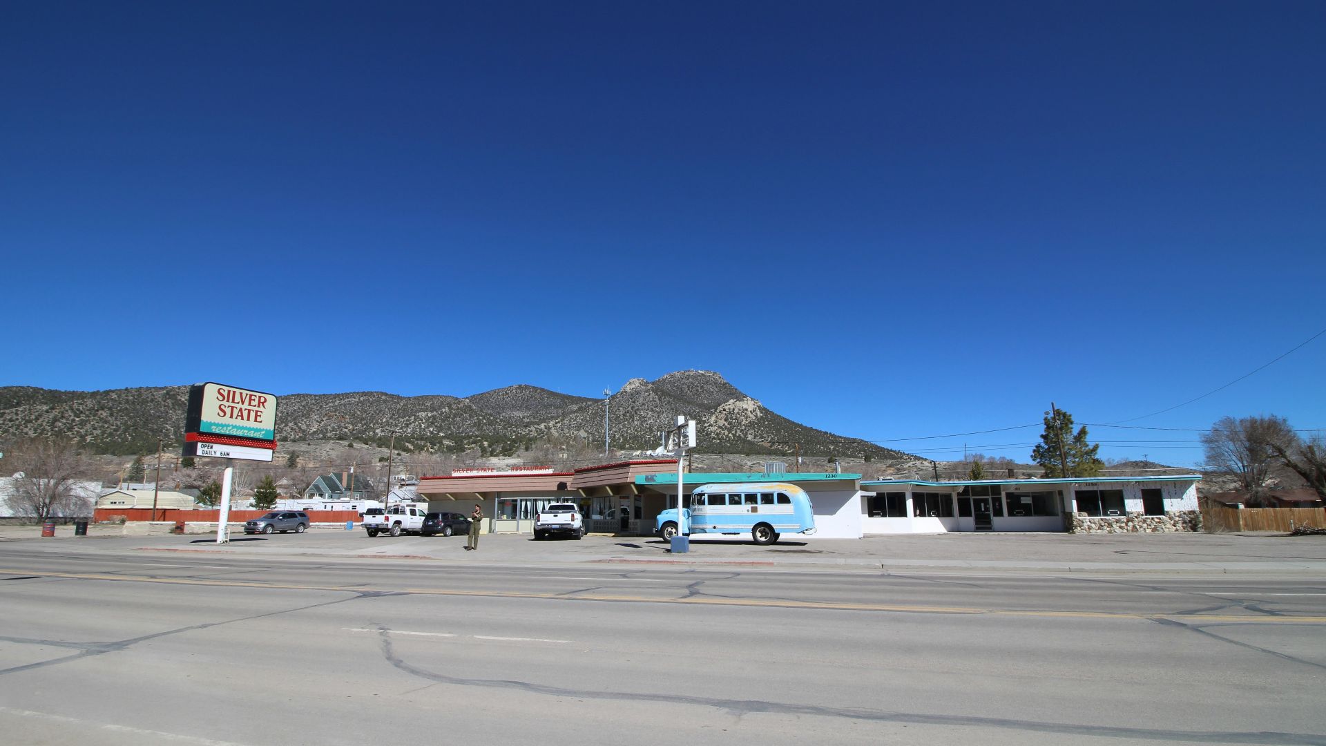 white and blue airplane on gray asphalt road during daytime