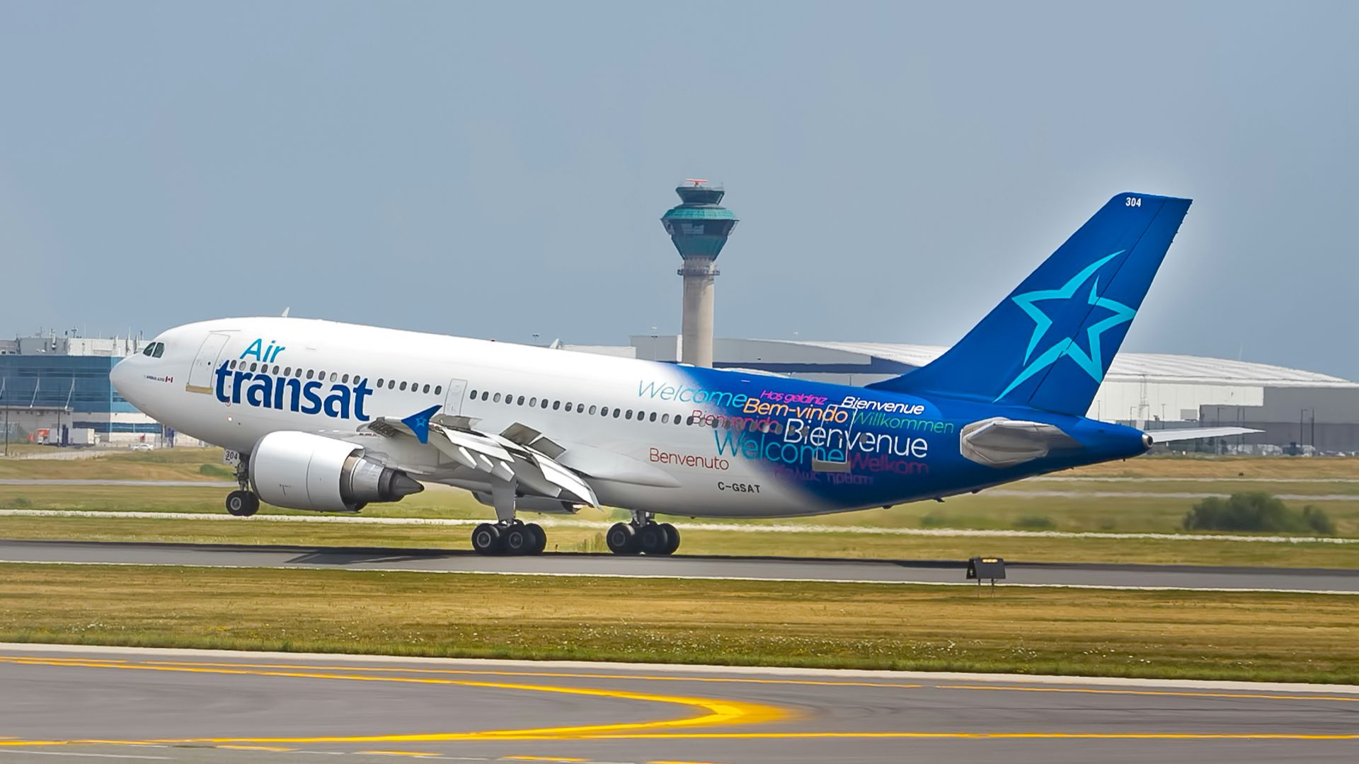 white and blue Transat airplane