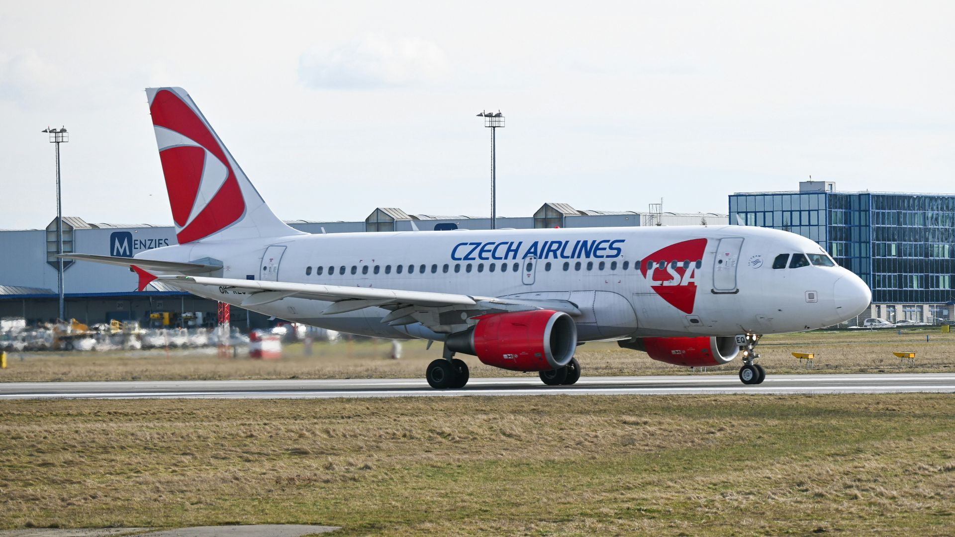 white and red passenger plane on brown field during daytime