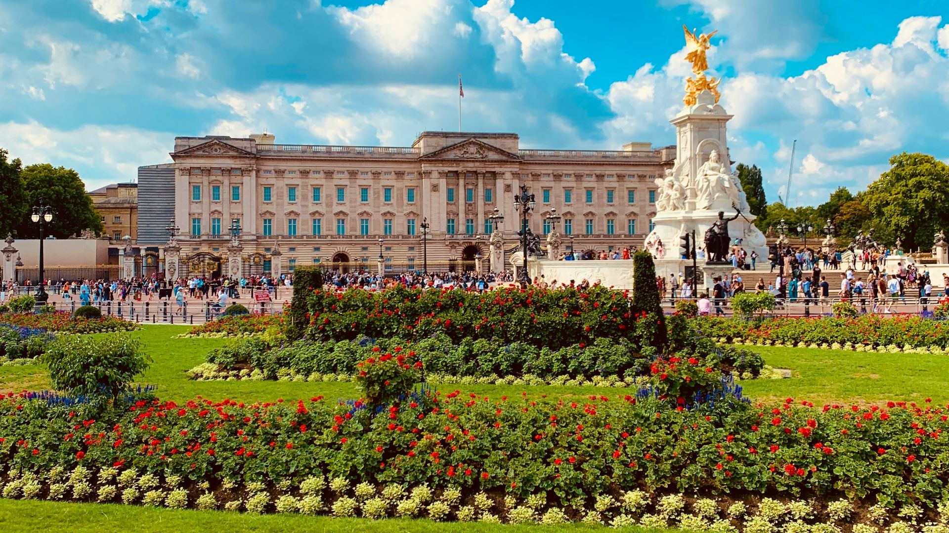 a large building with a statue in the middle of a garden
