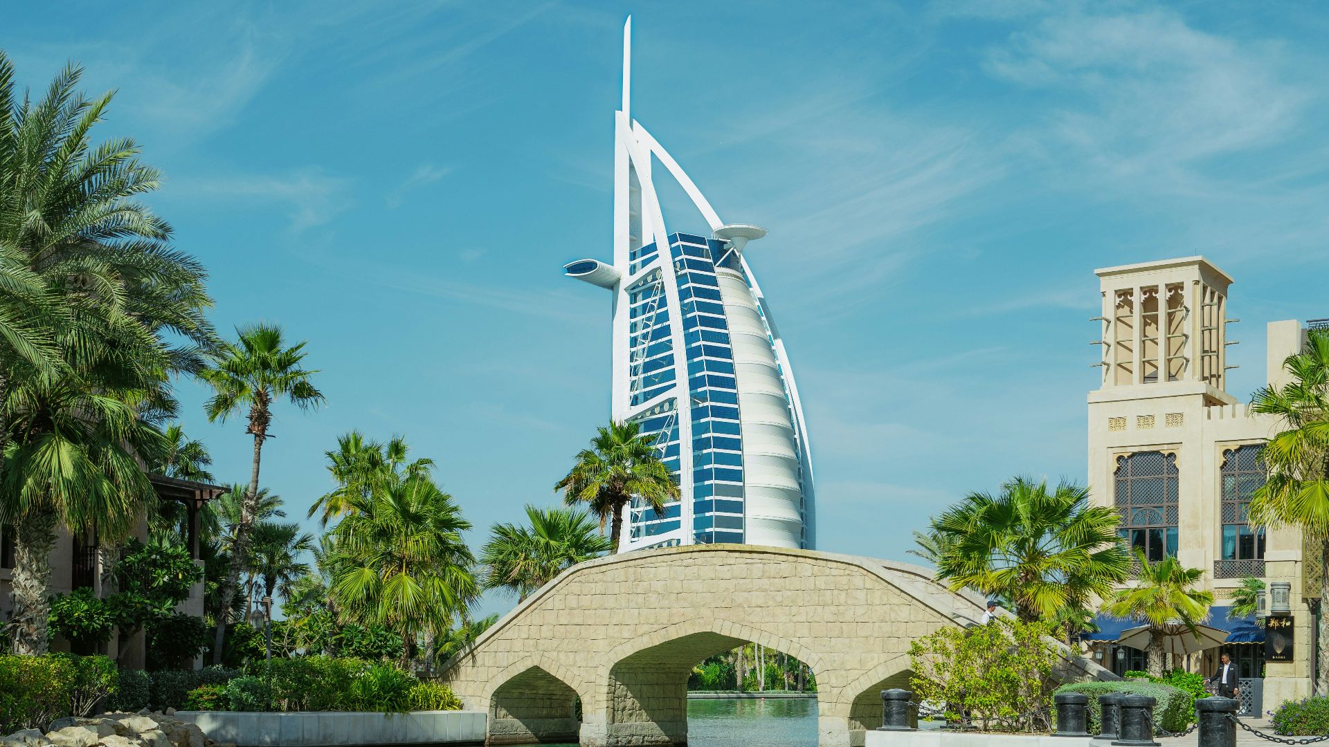 a bridge over a body of water with a building in the background