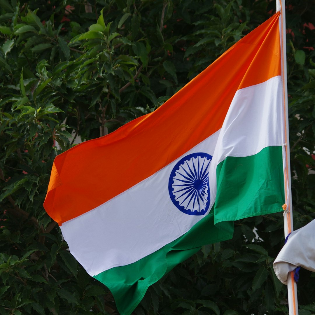 two flags are flying next to each other