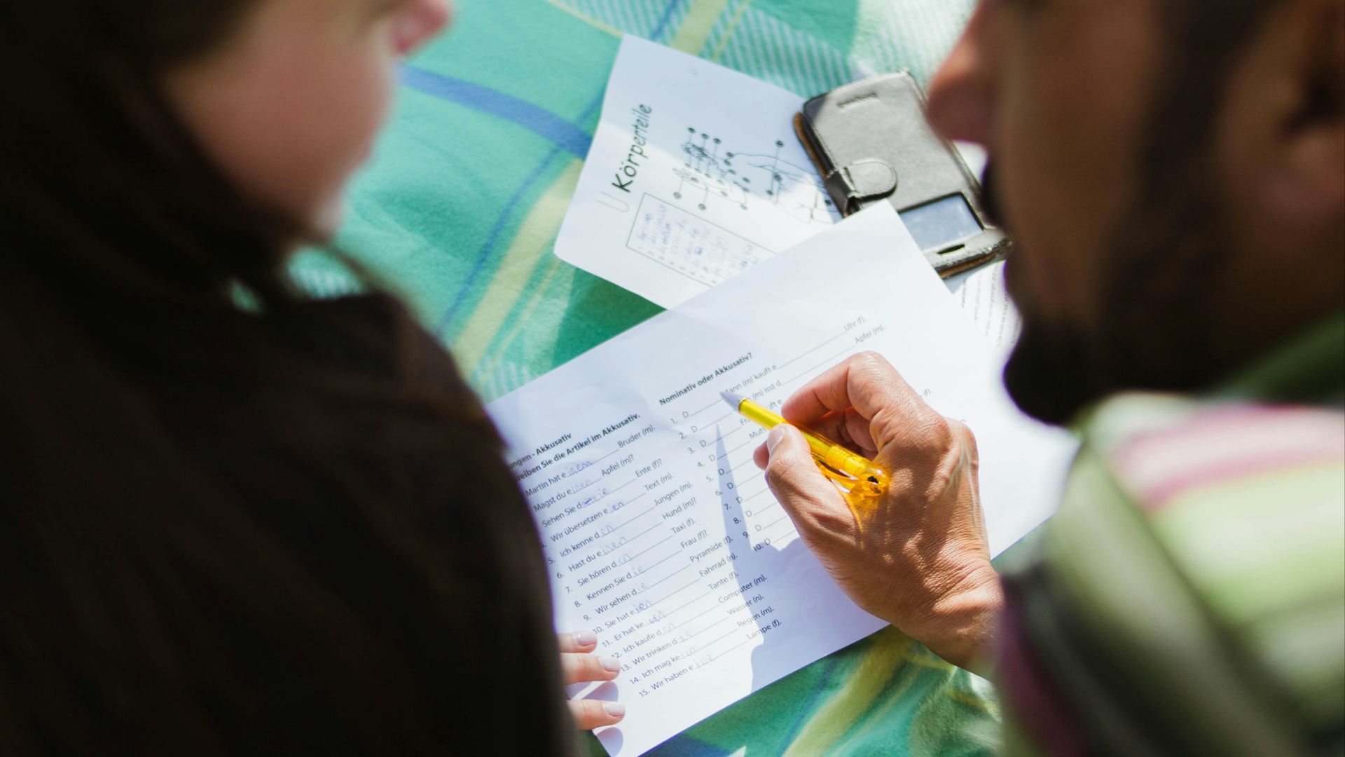 man in black shirt sitting beside woman in gray shirt
