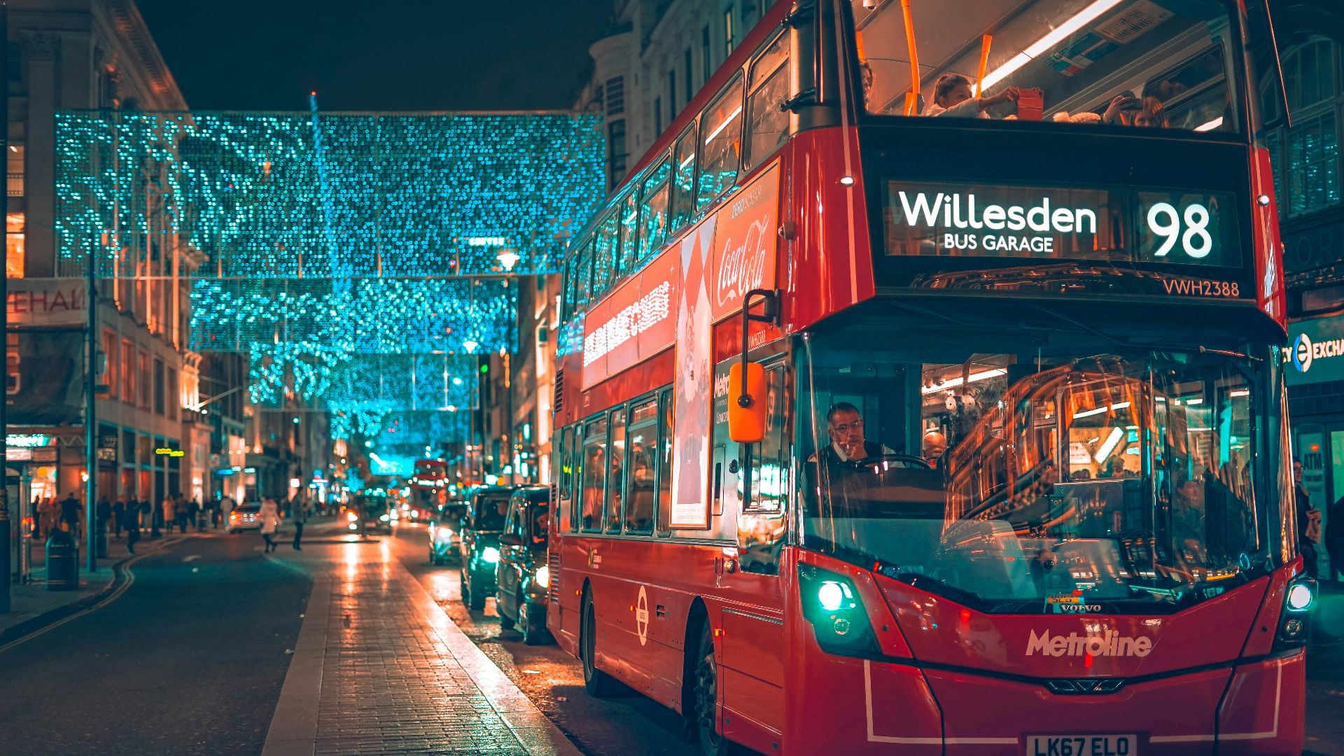 a red double decker bus driving down a street