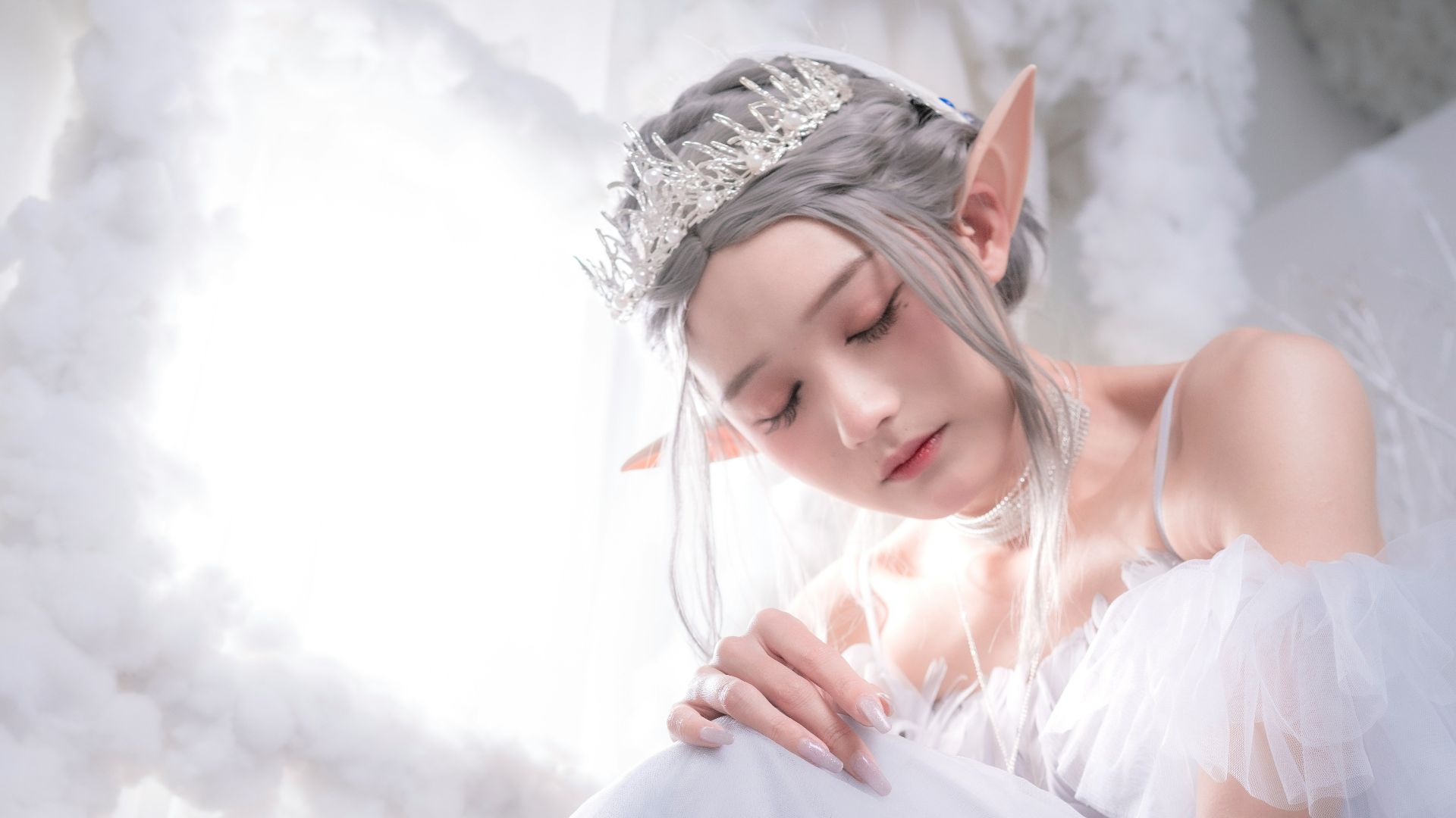 a woman in a white dress with a tiara