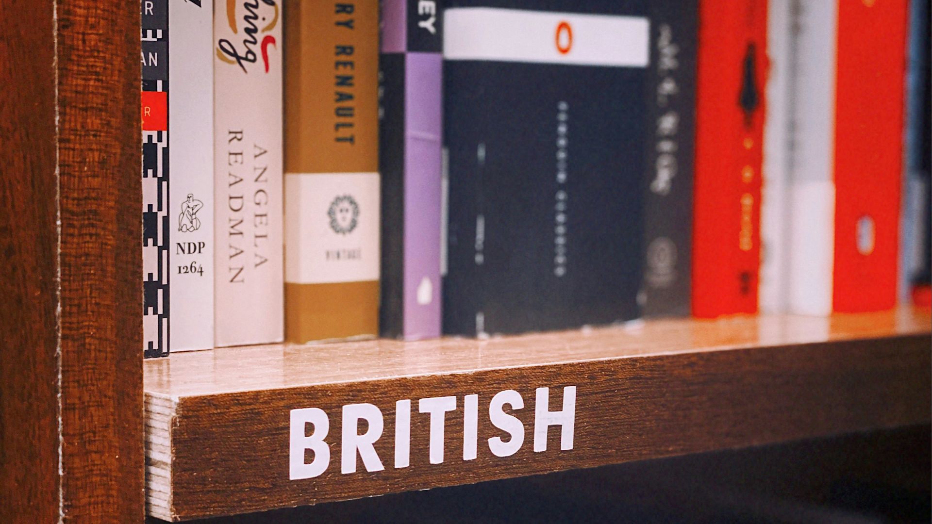 books on brown wooden shelf