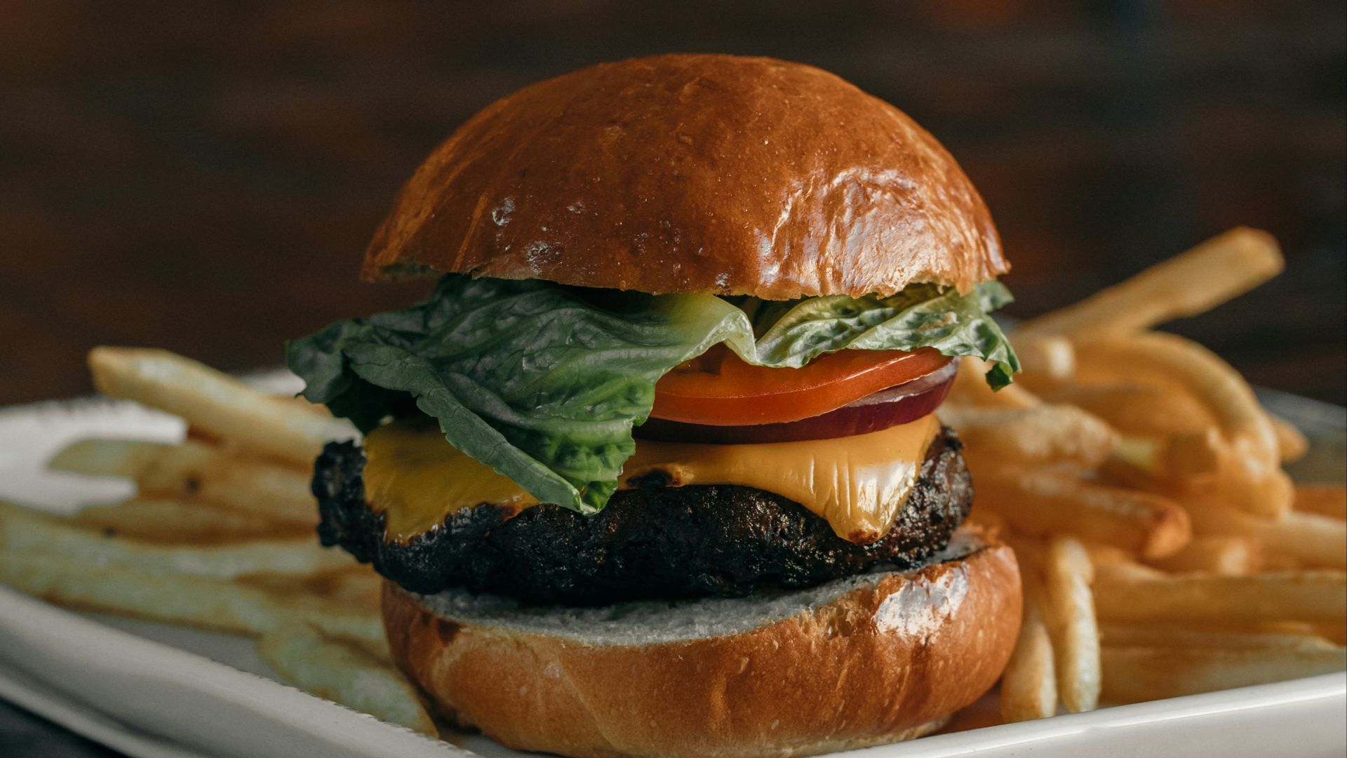 a cheeseburger and fries on a plate on a table