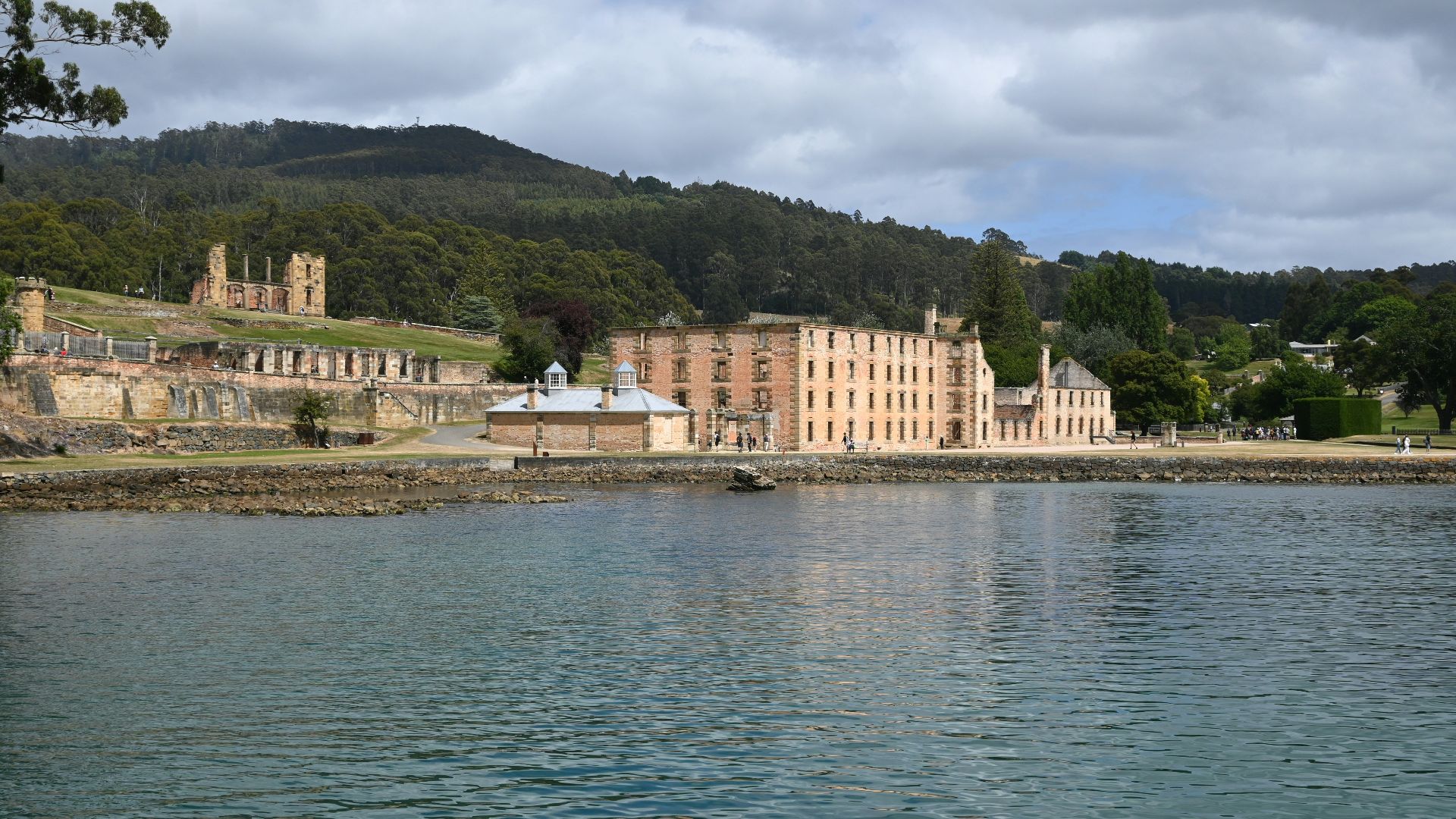 a large building sitting on the side of a lake