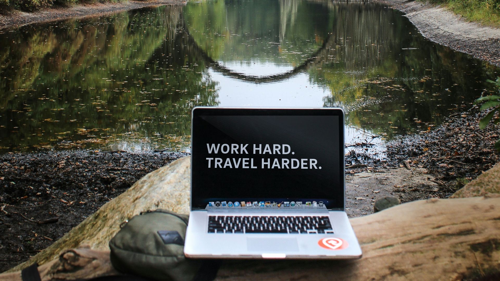 silver MacBook Pro on brown wood log