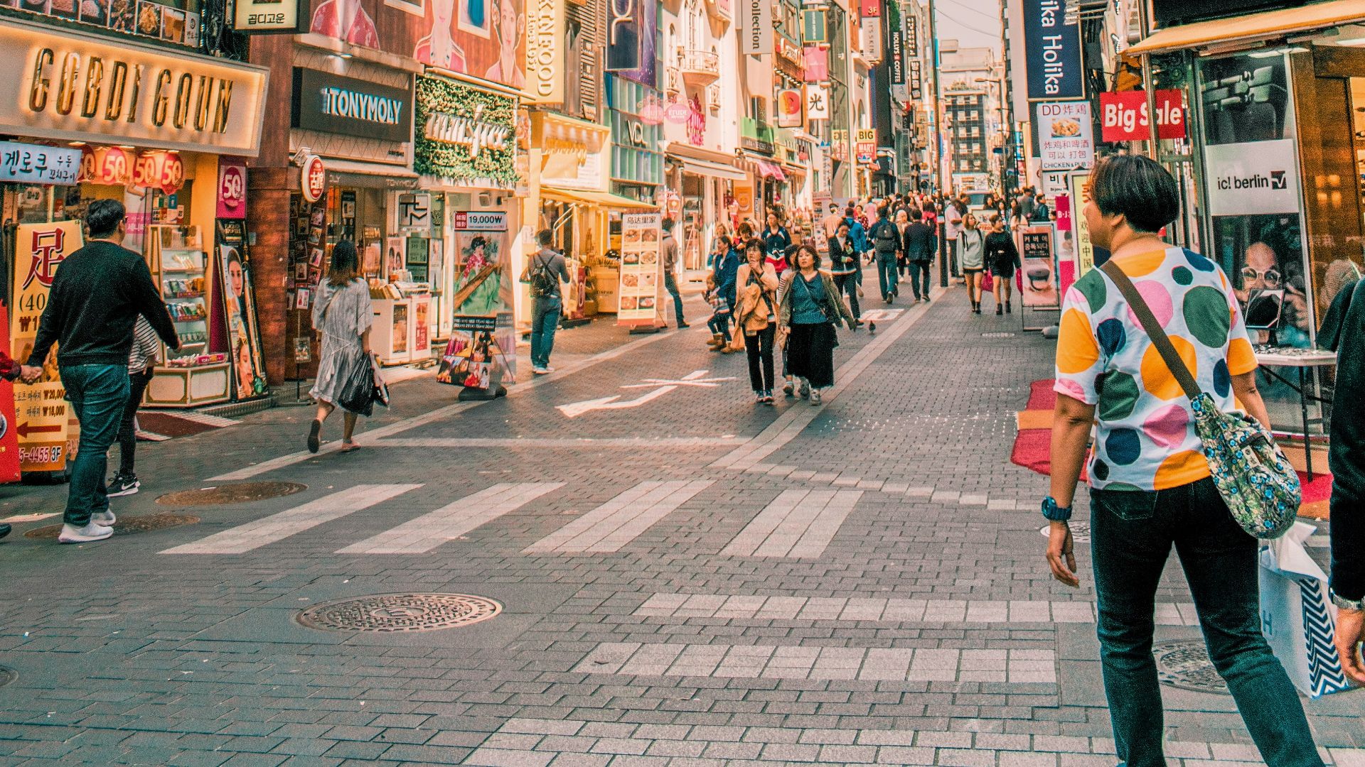 people walking on road surrounded by buildings