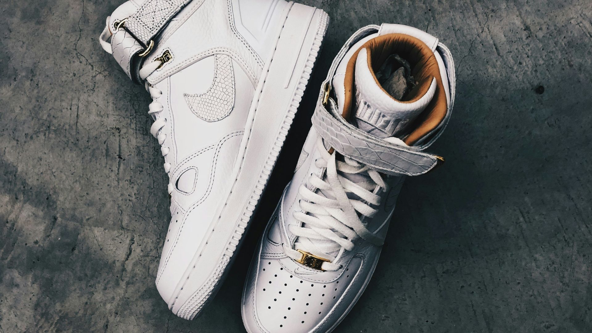 pair of white Nike high-top shoes