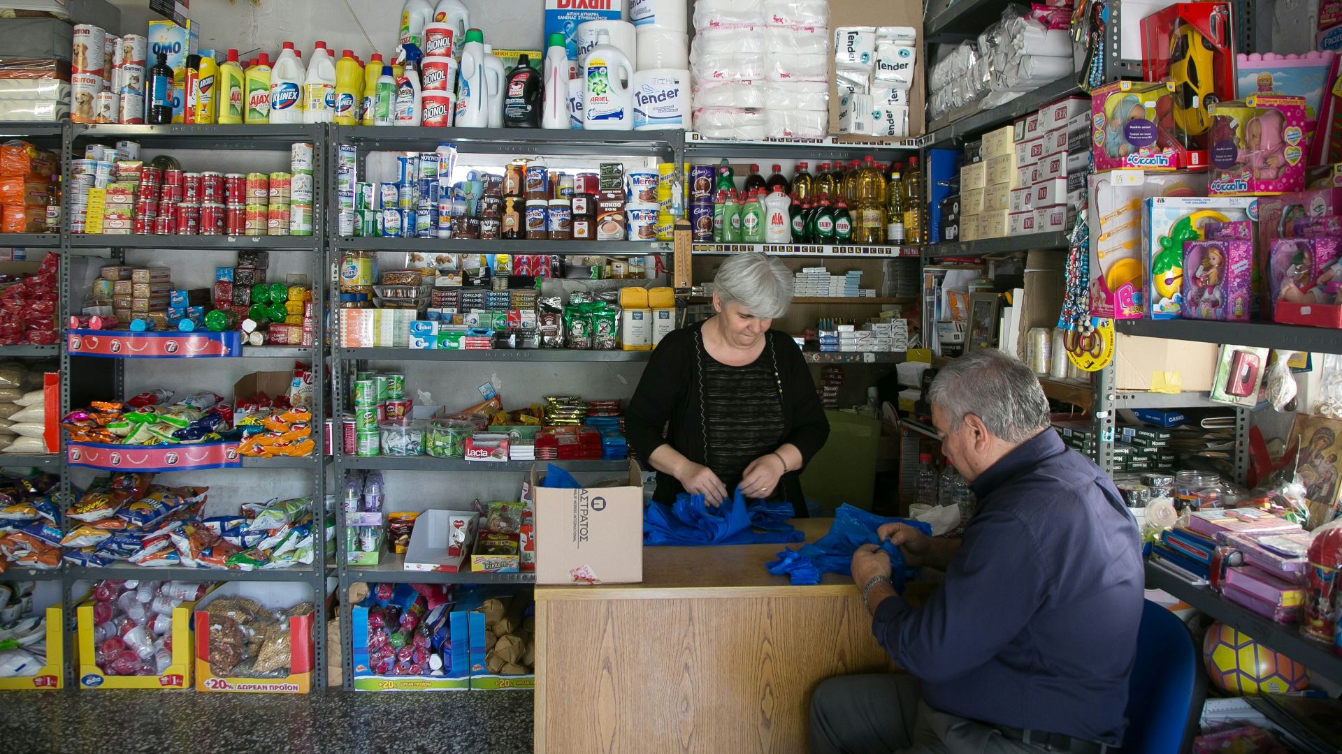 a man and a woman sitting at a counter in a store