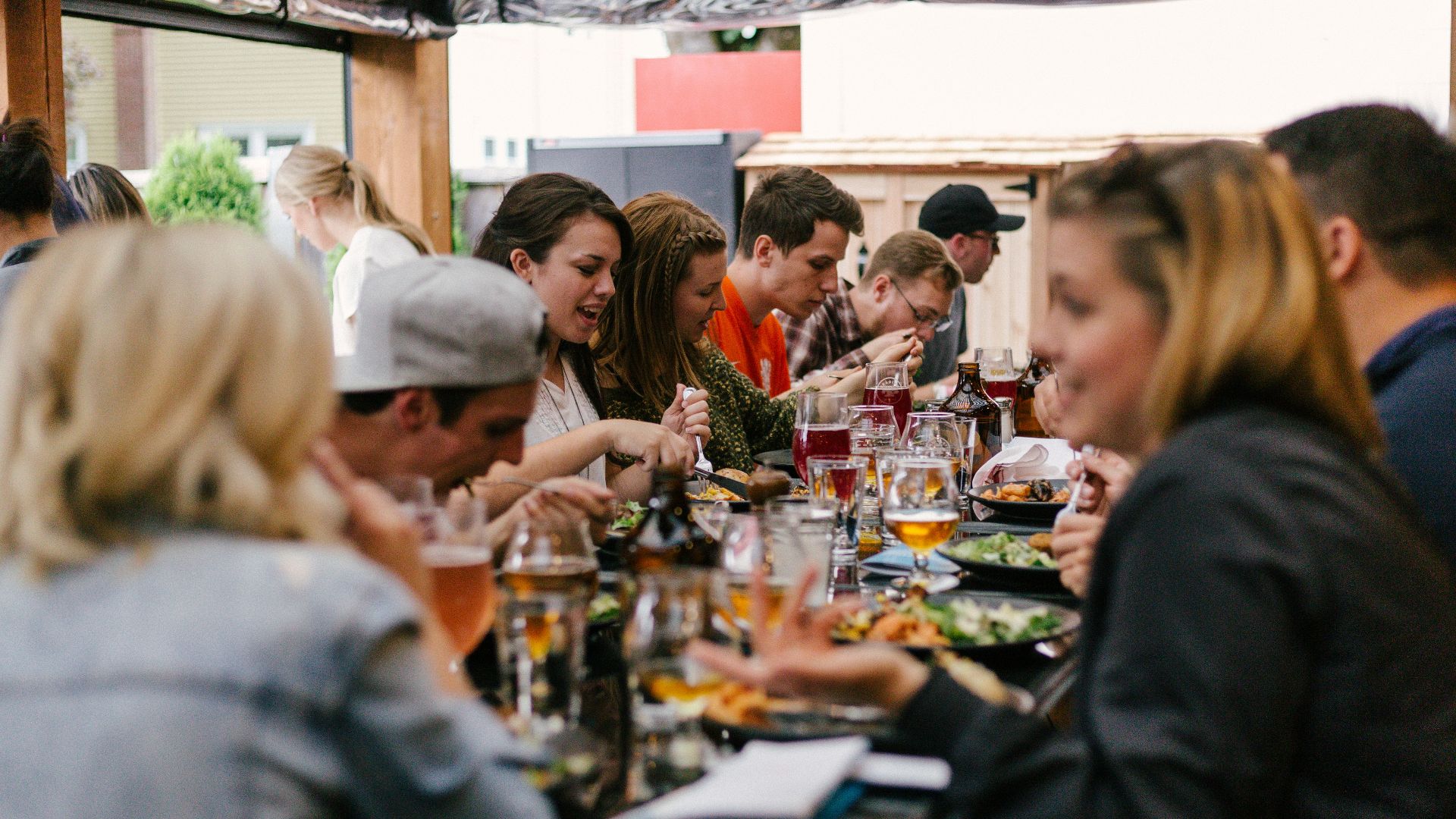 people sitting in front of table talking and eating