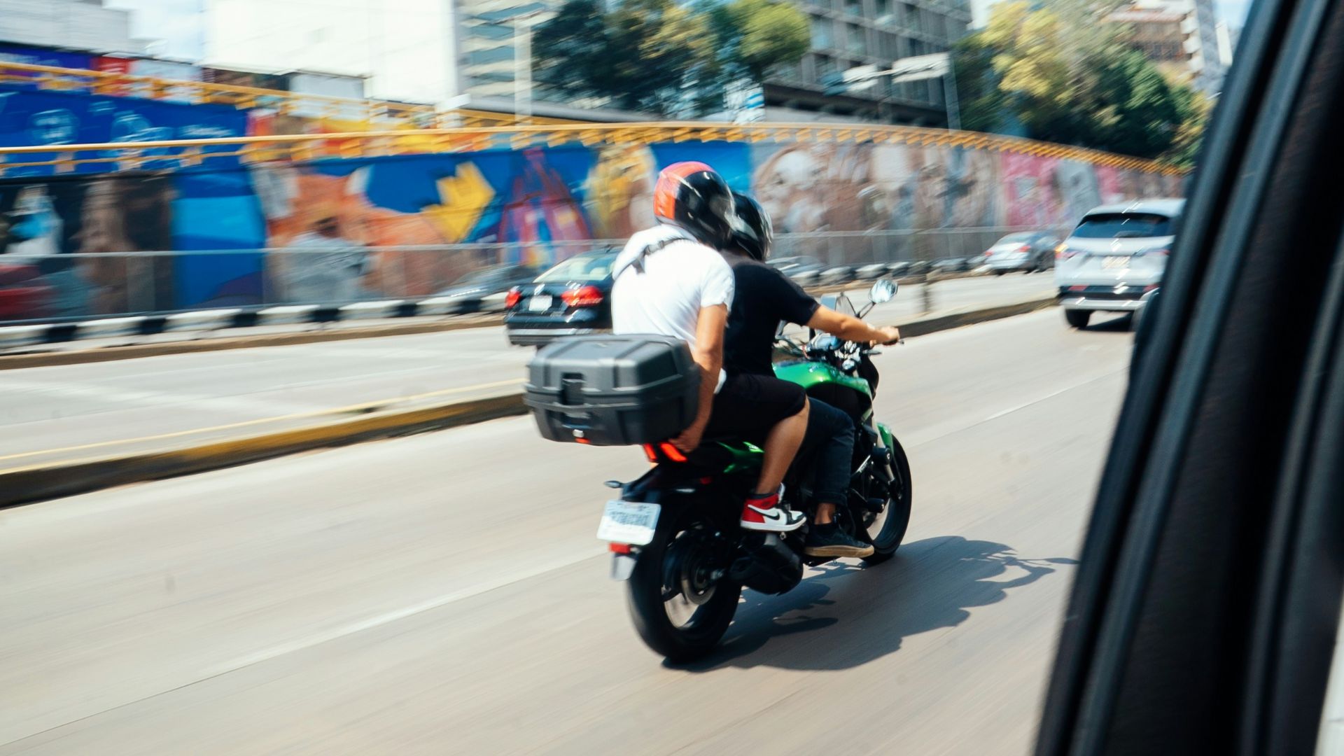a man riding a motorcycle down a street
