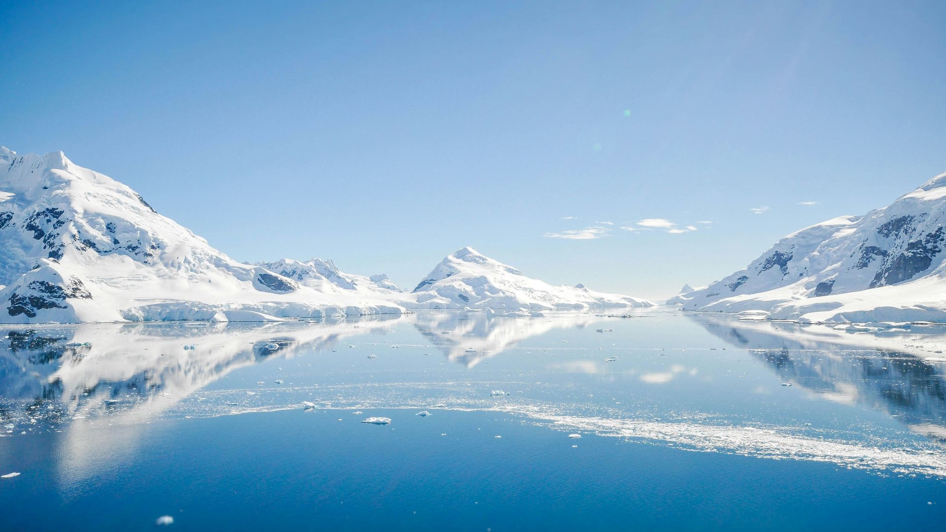 mountain with snow near body of water