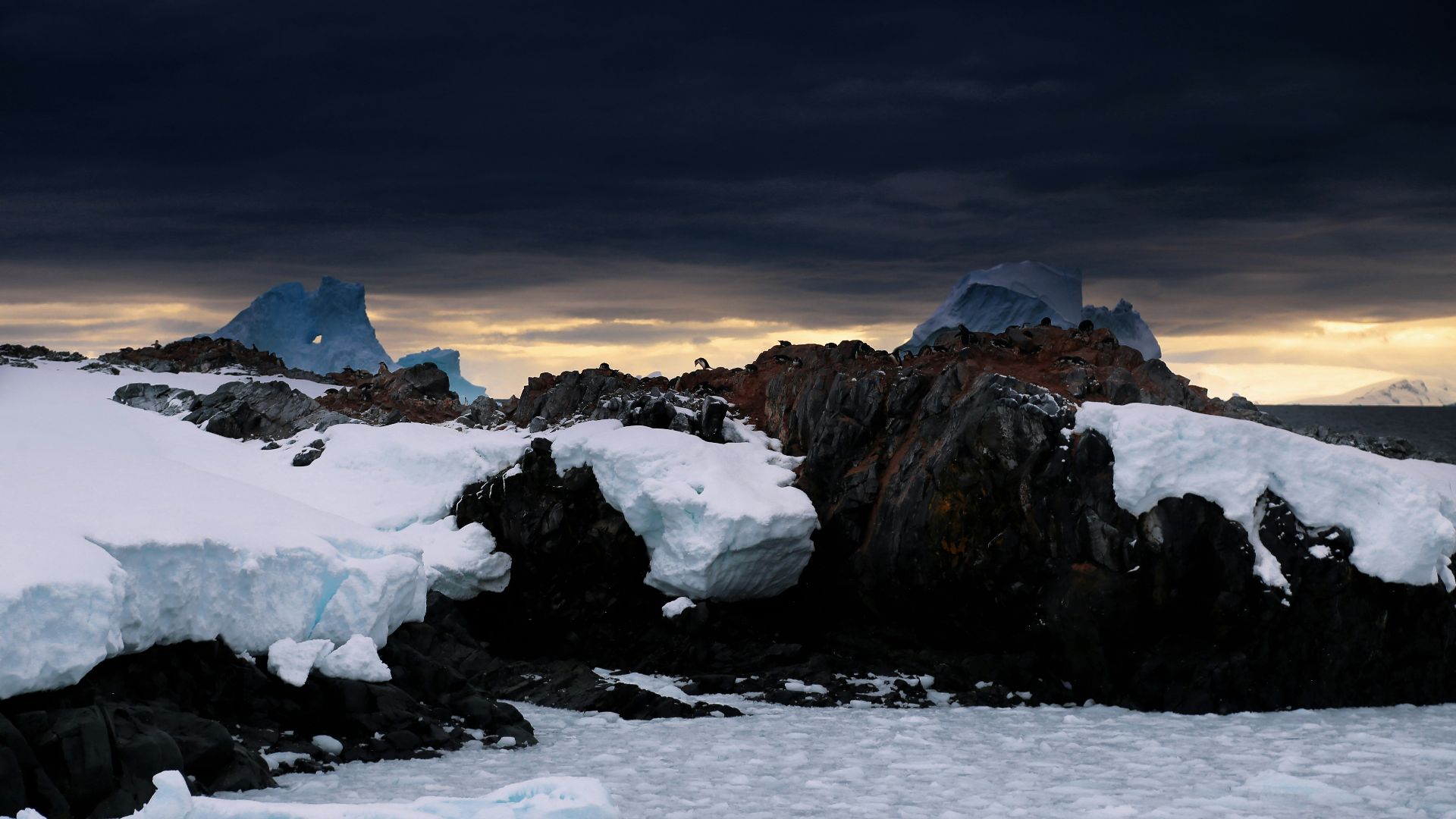 snow capped mountain under dark cloudy sky