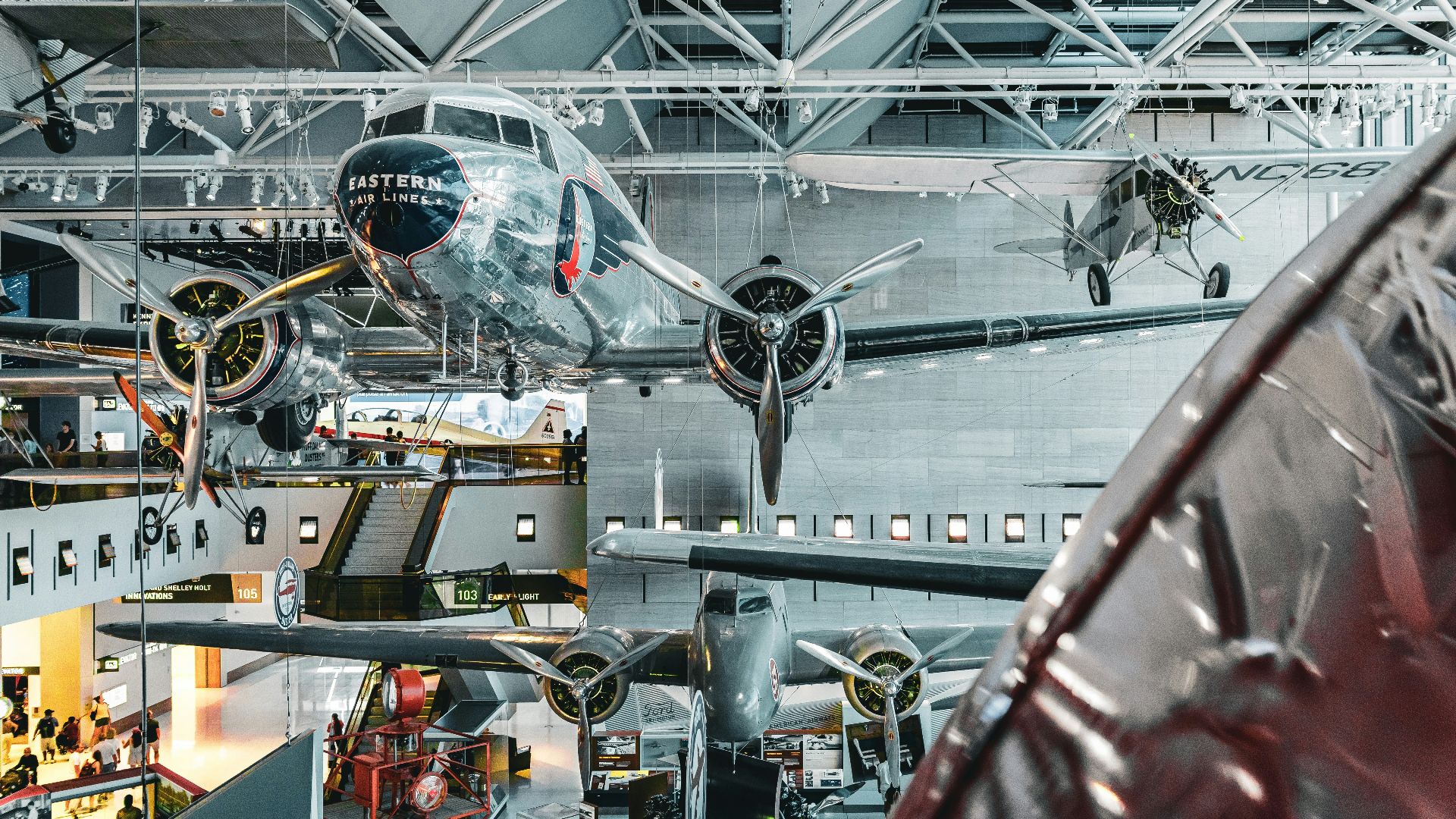 a large airplane hanging from the ceiling of a building