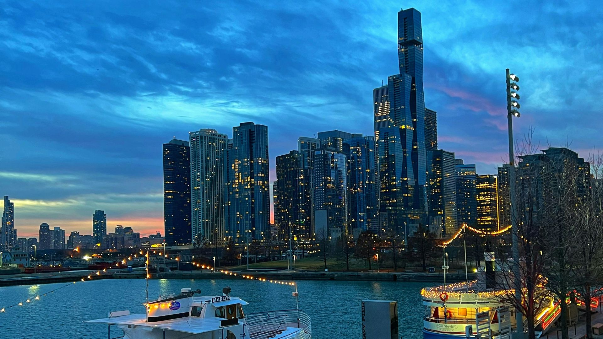 a city skyline with a body of water in the foreground