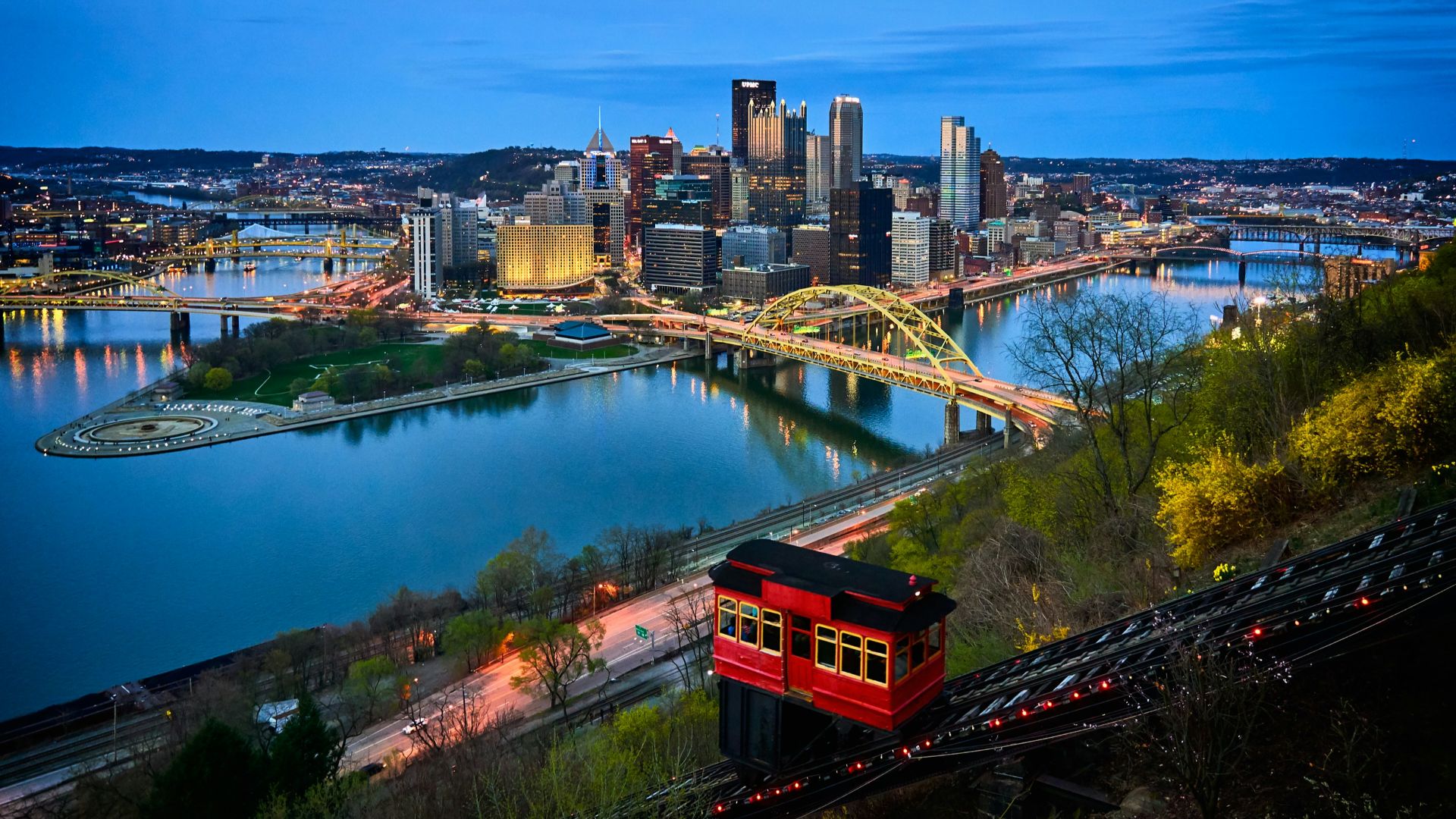 aerial photo of bridge and buildings under blue sky