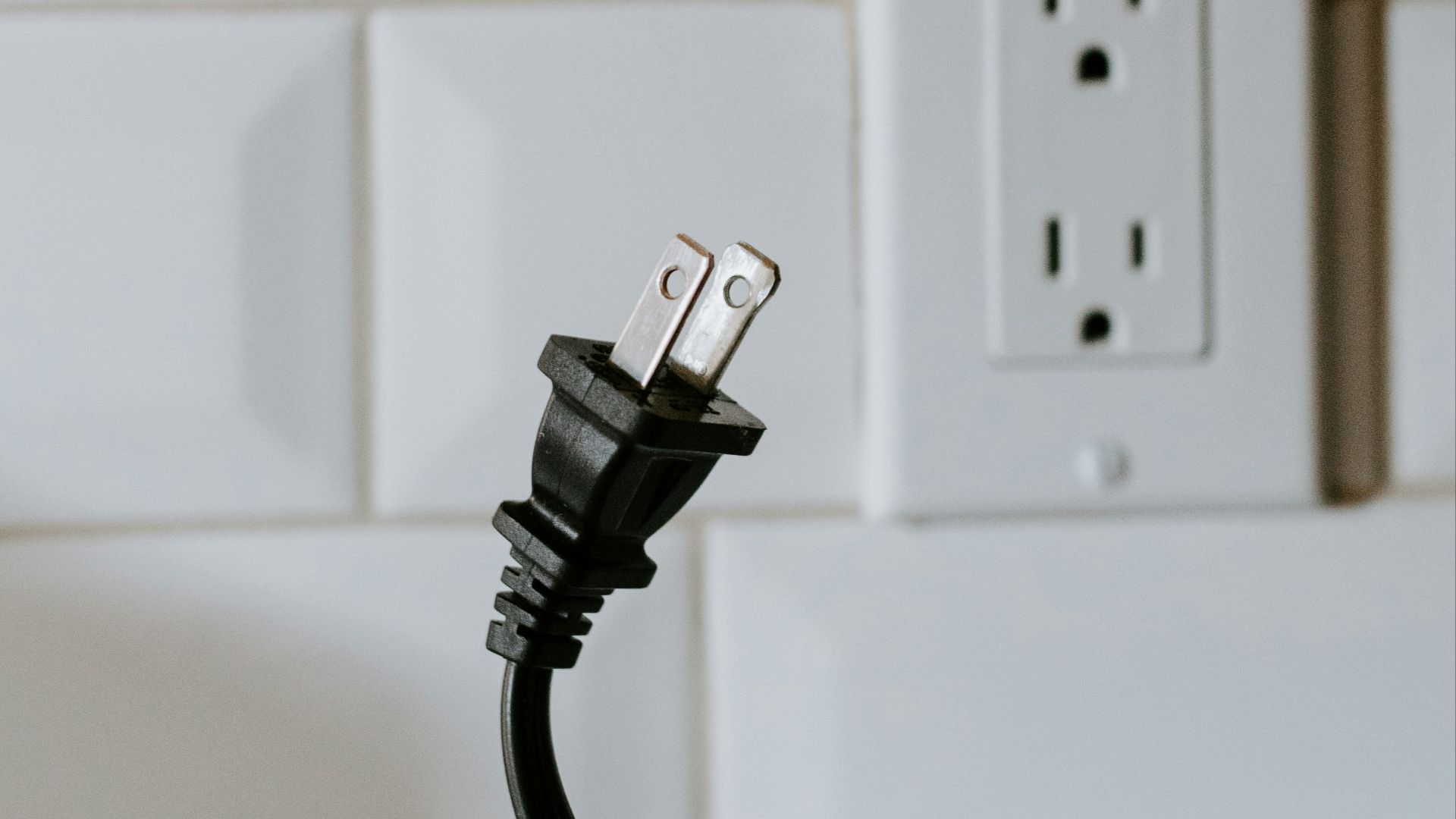 black usb cable plugged in white electric socket