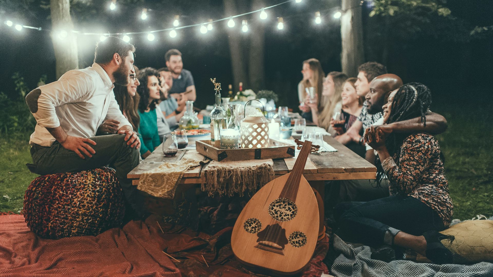 people sitting on chair in front of table with candles and candles
