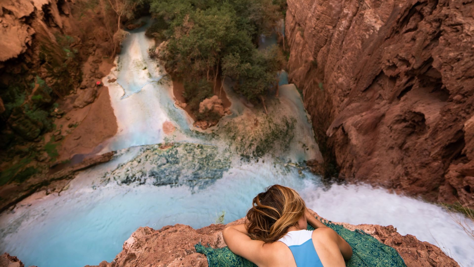 woman facing down on water falls