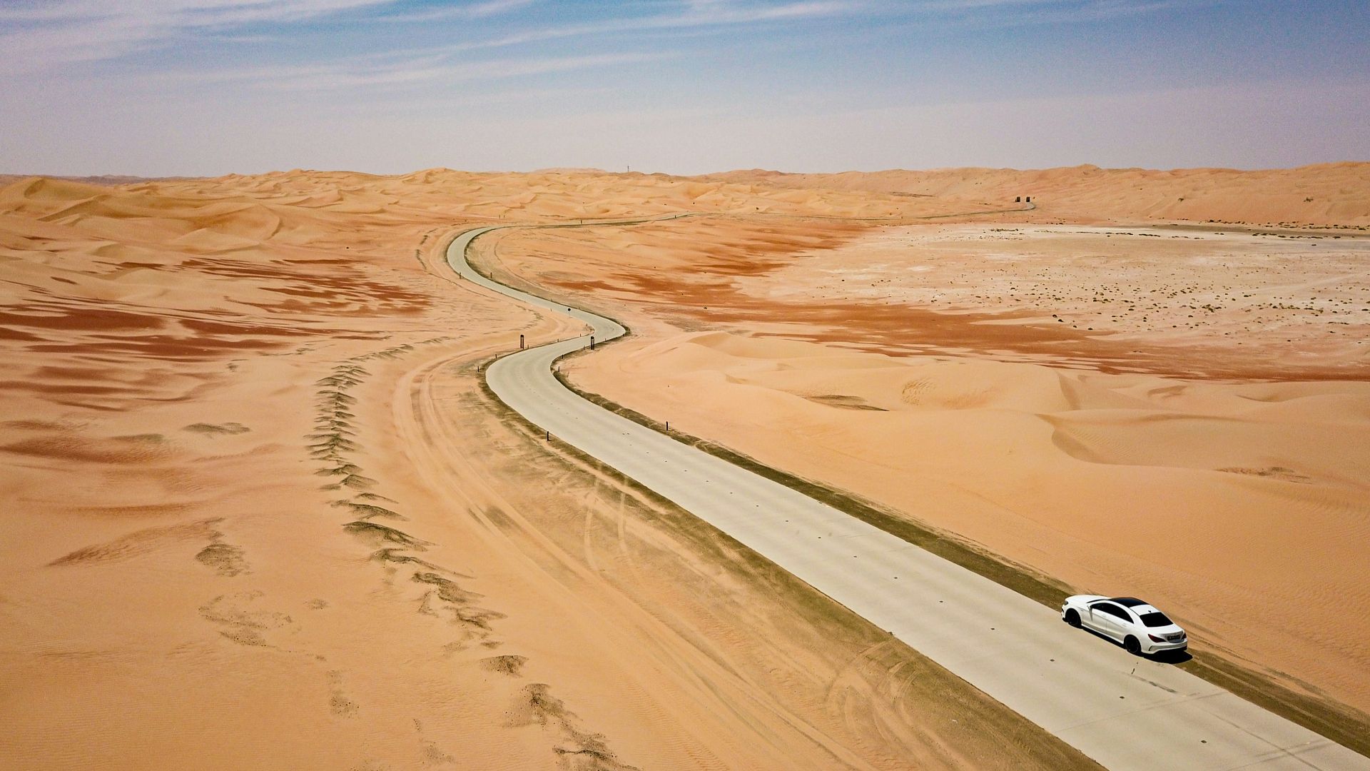 white car on brown sand