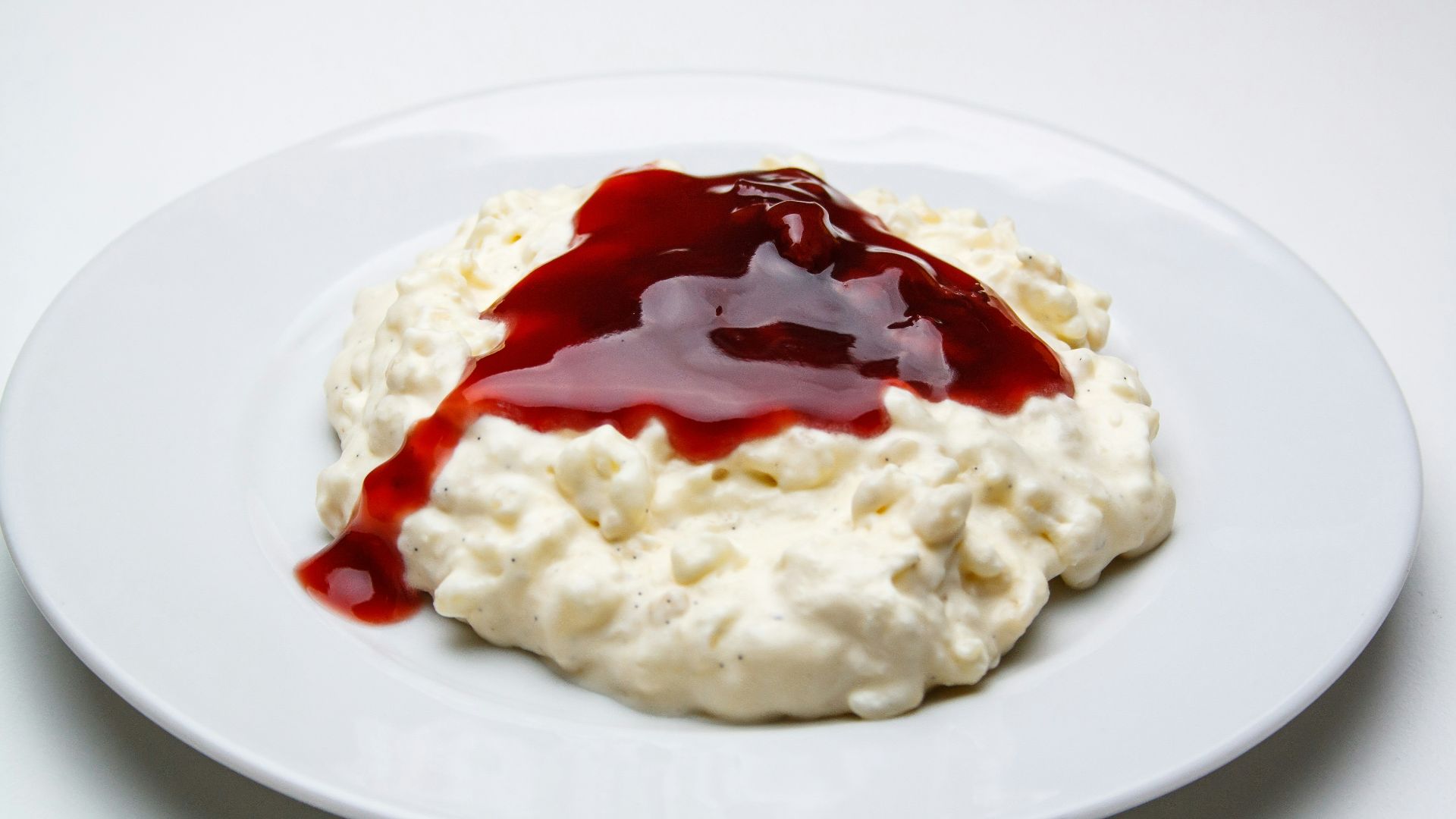 white rice with red sauce on white ceramic plate