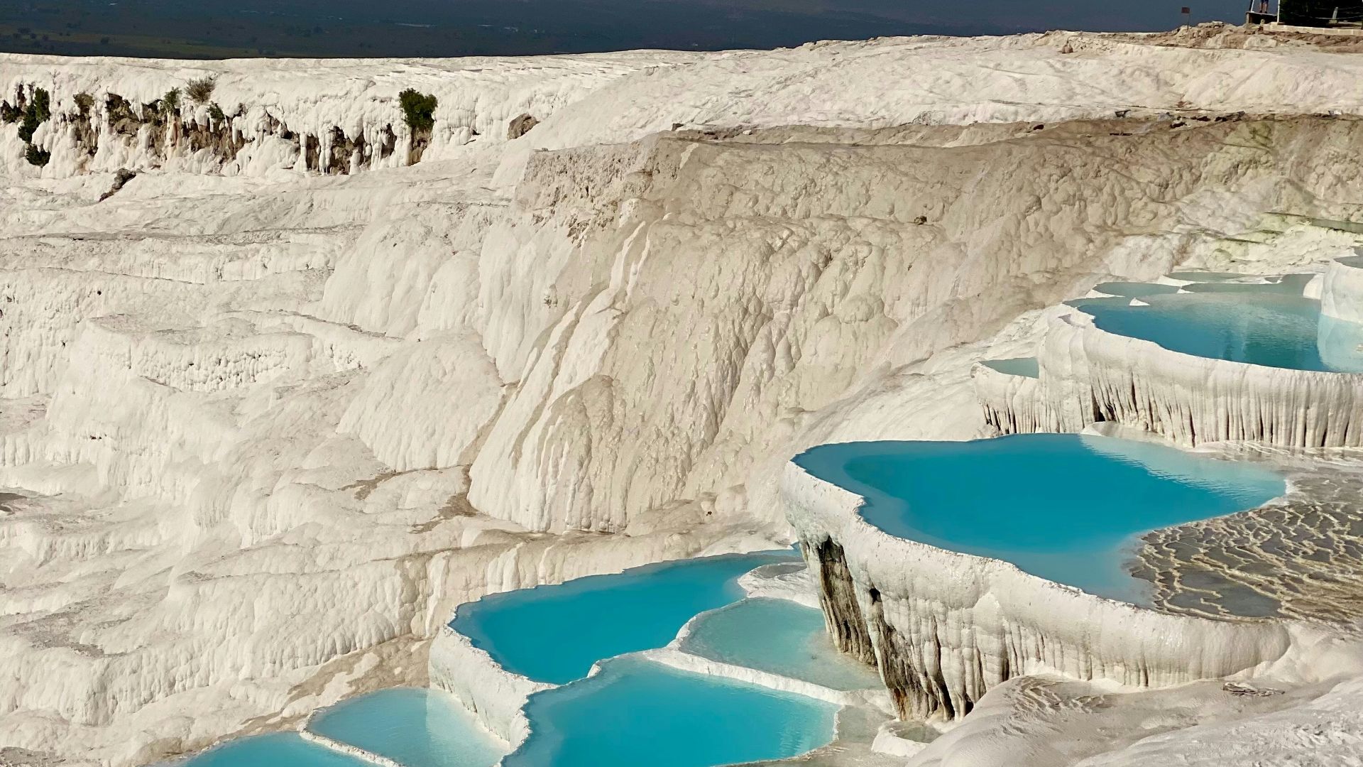 A group of people standing on top of a snow covered slope