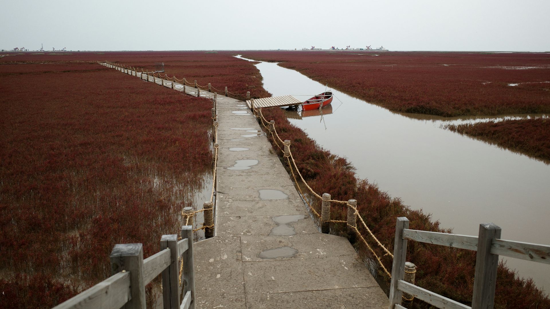 a path leading to a boat tied to a dock
