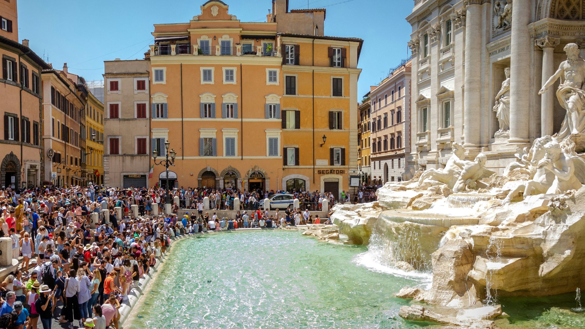 crowd of people gathered in front of Trevi Fountain